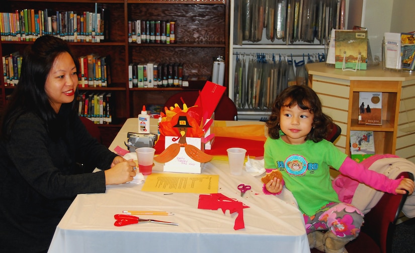 Evy Ray enjoys juice and cookies with her daughter Trisha after completing their Thanksgiving turkey at the Family Craft Night held at the Base Library here Nov. 12. Family Craft Nights as well as other programs, such as family reading nights and teen nights, are hosted at the base library and advertised through the 437th Force Support Squadron's "News You Can Do" e-mail and "The Scene" in the base newspaper. Mrs. Ray is the wife of Patrick Ray who is retired master sergeant with the 437th Medical Group. (U.S. Air Force photo/Staff Sgt. Daniel Bowles)