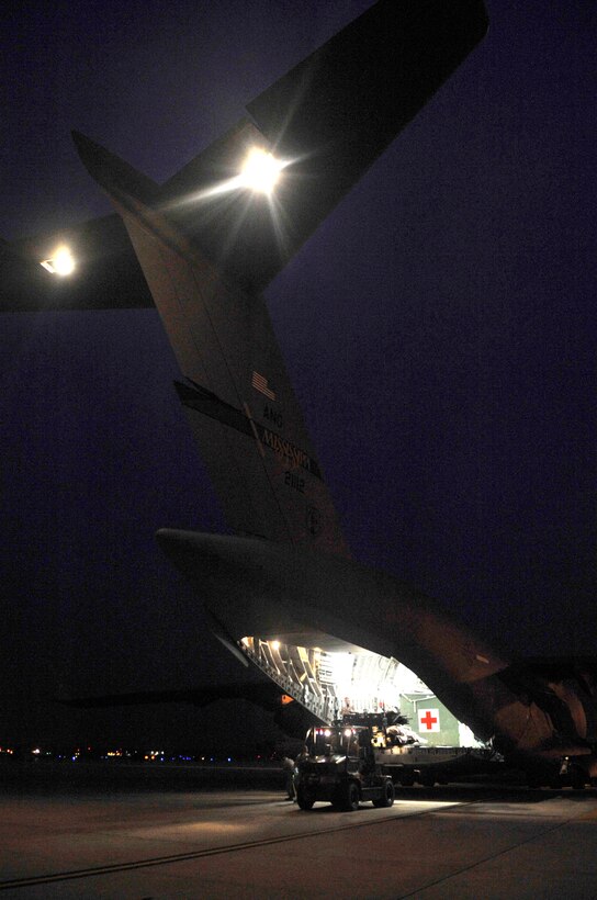 Members of the 779th Medical Group remove cargo from a C-17 Globemaster during an aeromedical evacuation flight Nov. 10, 2009, on Joint Base Andrews, Md. The 779th Aeromedical Staging Facility receives three flights per week containing over 50 patients from overseas, both war wounded and ill, that are returning for medical care. (U.S. Air Force photo by Staff Sgt. Renae Kleckner)