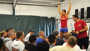 Justin and Heather, CrossFit certification staff from CrossFit headquarters, instruct Joint Team Andrews members on the “Push Press” exercise during a CrossFit Level 1 certification class in the Tactical Fitness Center Saturday. The two-day seminar for selected unit physical training leaders included a variety of lectures such as defining CrossFit, proper nutrition, and how to coach  high intensity, constantly varied and functional whole body workouts. Thirty-eight Joint Team Andrews students were certified as CrossFit coaches to better enhance Andrews fitness program from within the unit structure. (U.S. Air Force photo/ Airman 1st Class Melissa Rodrigues)