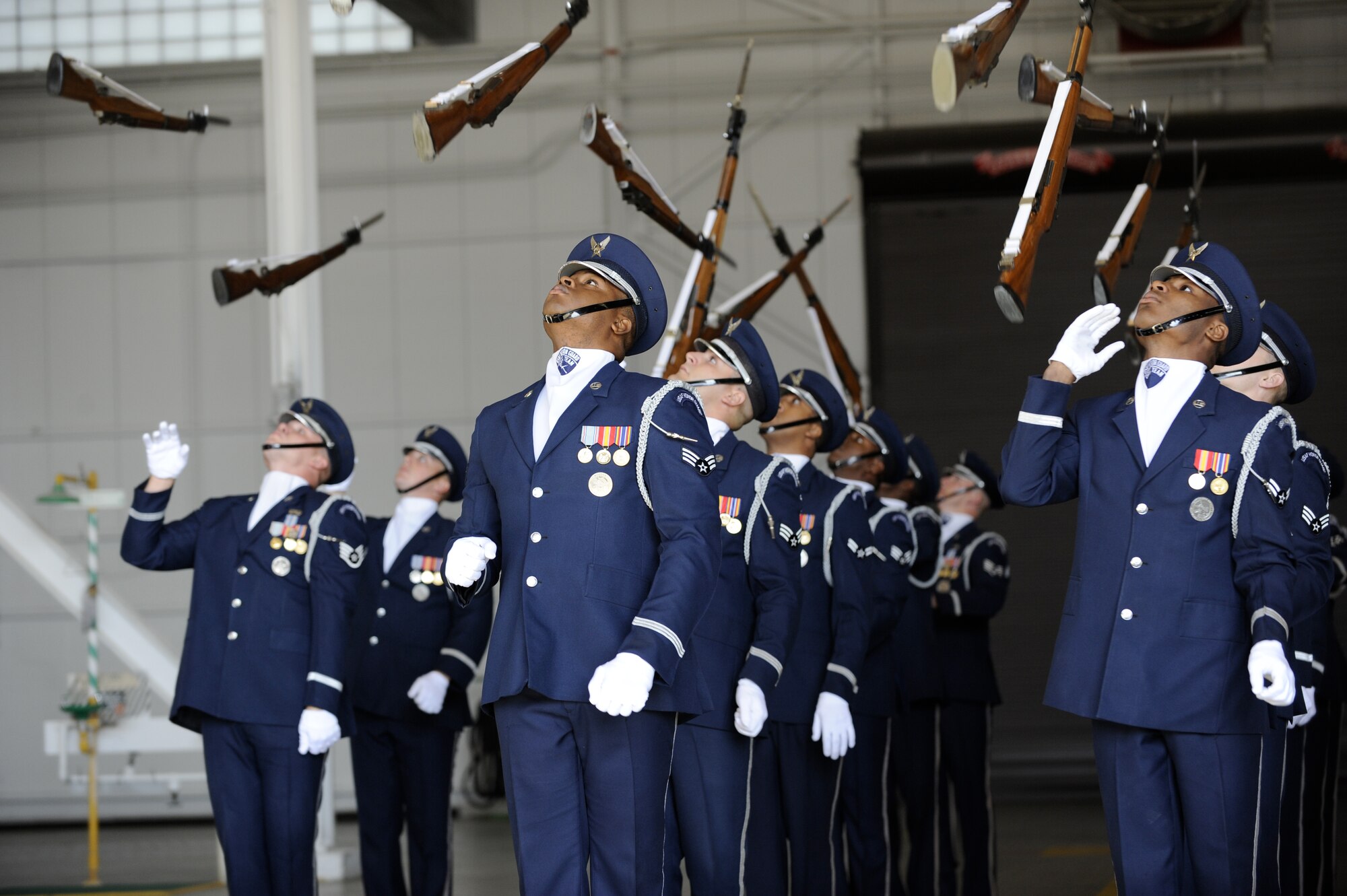 The Air Force Honor Guard Drill Team performs at Joint Base McGuire-Dix-Lakehurst, Nov.16. A standard 16-person performance features a professionally choreographed sequence of show-stopping weapon maneuvers, precise tosses, complex weapon exchanges and moving through a gauntlet of spinning weapons.(U.S. Air Force Photo/Carlos Cintron)
