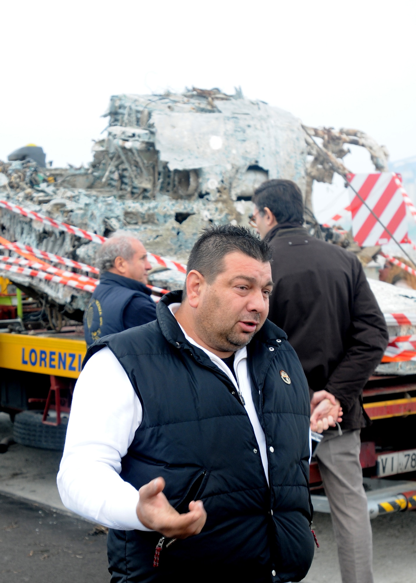 Italian fisherman Filippo Salvagno conducts an interview with Senior Airman Jamie Ciciora, a broadcaster from Aviano Air Base, Italy following a ceremony Nov. 14, 2009 at the Chioggia Lagoon.  Mr. Salvagno recovered a large section of an aircraft wreckage, believed to be a World War II Army Air Force P-47 Thunderbolt fighter, that crashed into the Adriatic Sea in the mid-1940’s during a fishing expedition in May 2009.  (U.S. Air Force photo/Airman LaVel D. Sterling)