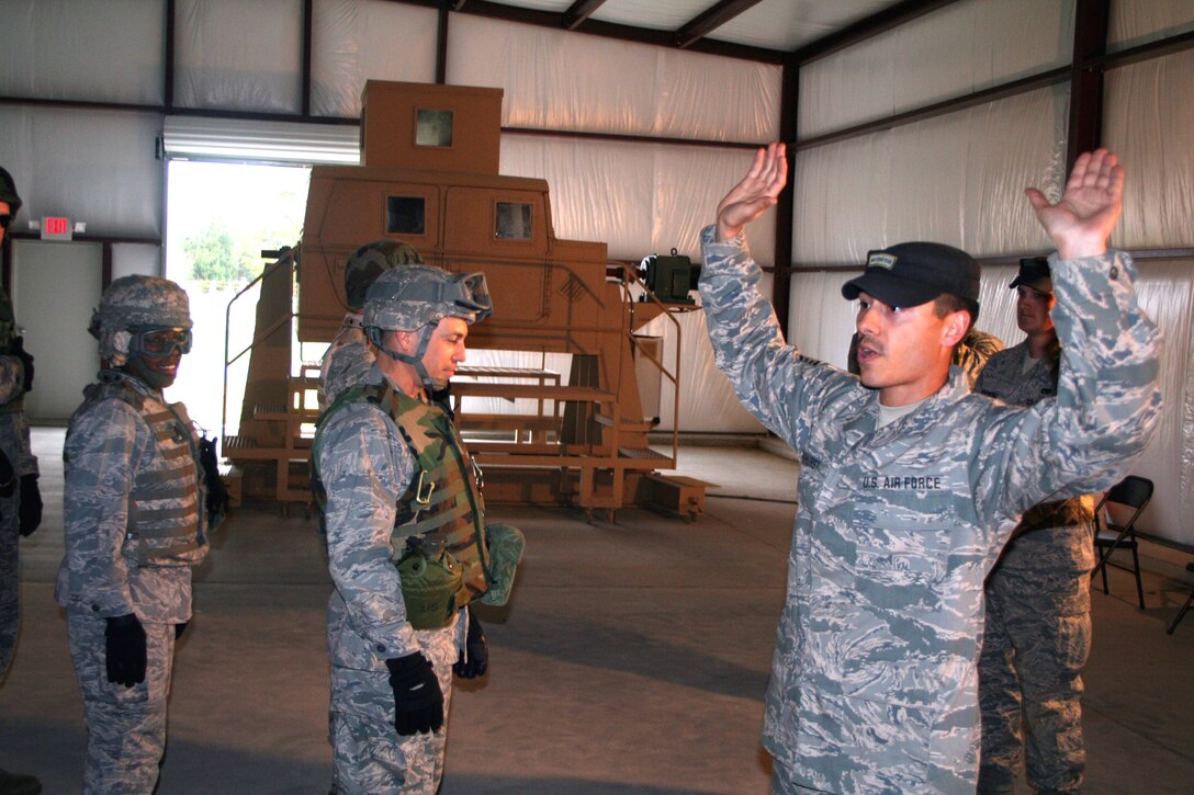 Staff Sgt. Travis Parkhurst, combat skills training instructor, shows students in the Combat Airman Skills Training Course 10-1A the proper way to handle a vehicle roll-over in a high-mobility, multi-wheeled vehicle, or HMMWV, during HMMWV egress training in the course on Nov. 11, 2009, at Joint Base McGuire-Dix-Lakehurst, N.J.  The CAST course, taught by the U.S. Air Force Expeditionary Center's 421st Combat Training Squadron, prepares Airmen for upcoming deployments.  (U.S. Air Force Photo/Tech. Sgt. Scott T. Sturkol)