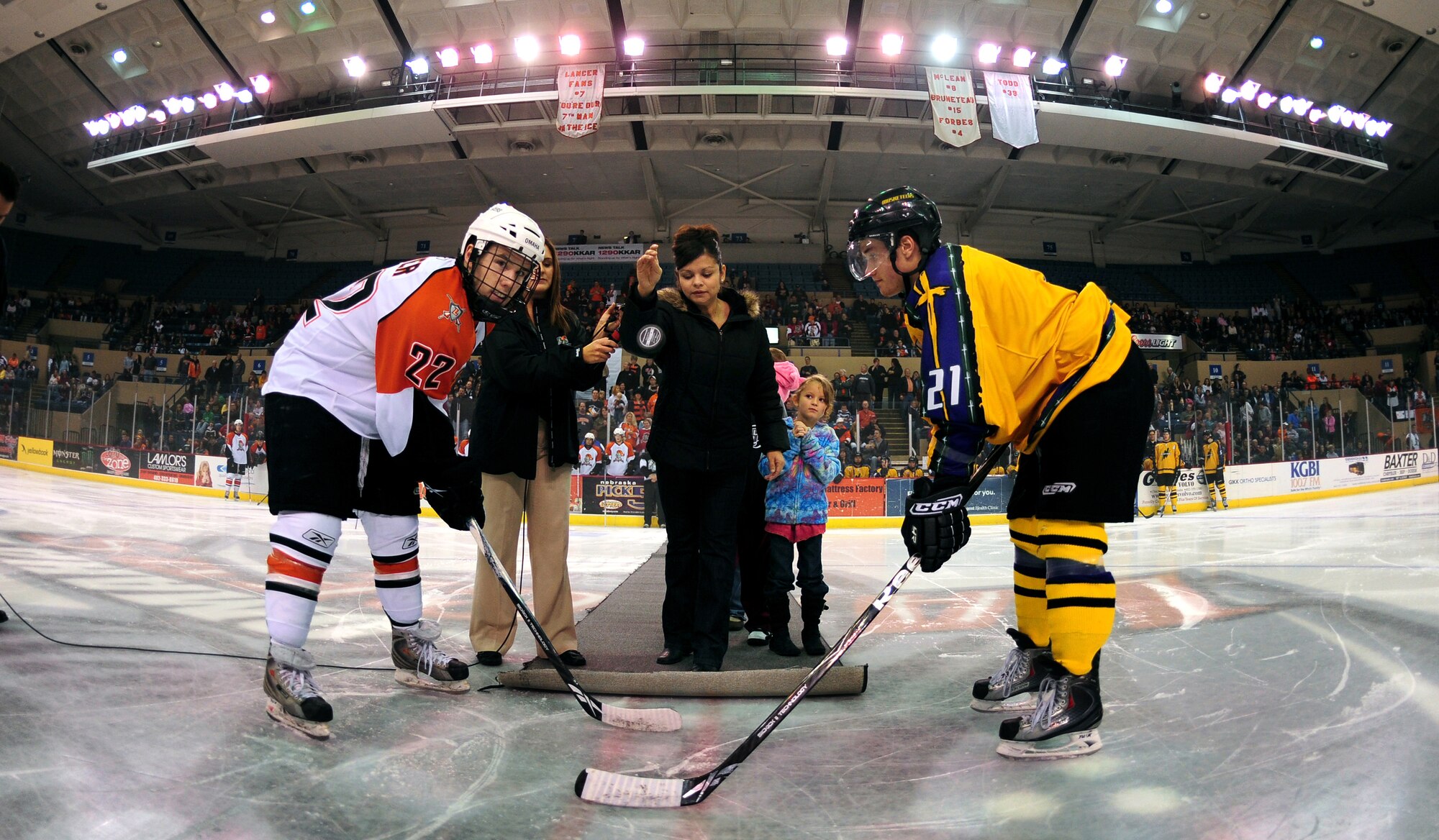 OFFUTT AIR FORCE BASE, Neb. - Ramona C. Price, spouse of deployed Senior Master Sgt. Bruce Price with the 55th Strategic Communications Squadron, is the guest of honor as she performs the ceremonial puck drop at the Civic Auditorium in Omaha, Neb., Nov. 13 to begin the military appreciation game between the Omaha Lancers and the Sioux City Musketeers. Mrs. Price and her children not only participated in the puck drop, but were also surprised with a live telephone feed as Sergeant Price spoke to them from a deployed location in Afghanistan.
U.S. Air Force photo by Josh Plueger
