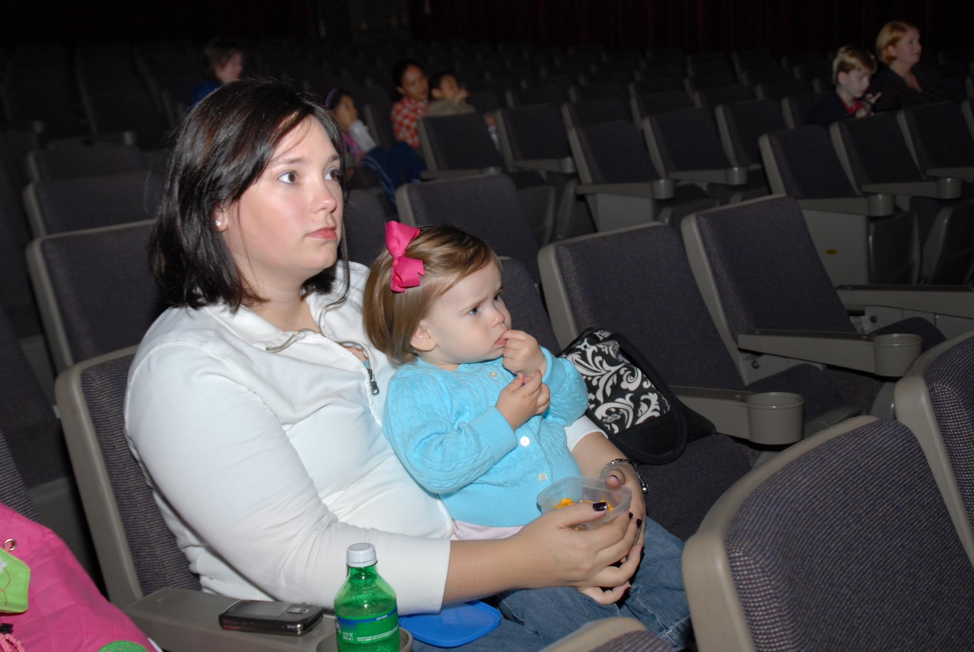 Kristen Boyer and Brooke Boyer, family members of Tech. Sgt. Casey Boyer, 19th Logistics Readiness Squadron aerial delivery supervisor, attend a special screening Nov. 14 of the Disney Pixar film “Finding Nemo” for children with special needs. The event was sponsored by the base’s Exceptional Family Member Program. (U.S. Air Force photo by Senior Airman Nathan Allen)