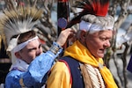 Richard Shelton, a student at the University of Texas San Antonio, adjusts the headdress on Retired Lt. Col. Jim Strye in preparation for the native dance they performed for the American Indian Heritage Exhibit here Nov. 13.  (U.S. Air Force Photo by Don Lindsey)