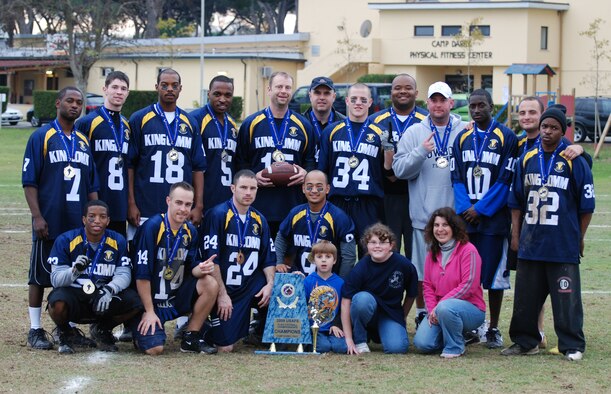 Team King Comm poses for photos with their first place trophy after competing in the U.S. Air Forces in Europe Flag Football Championship in Camp Darby, Italy, Nov. 12 through 16. The 86th Communications Squadron football team won the championship 20-19 in double overtime against the Camp Darby team. (Photo by Joyce Costello, courtesy of the U.S. Army)