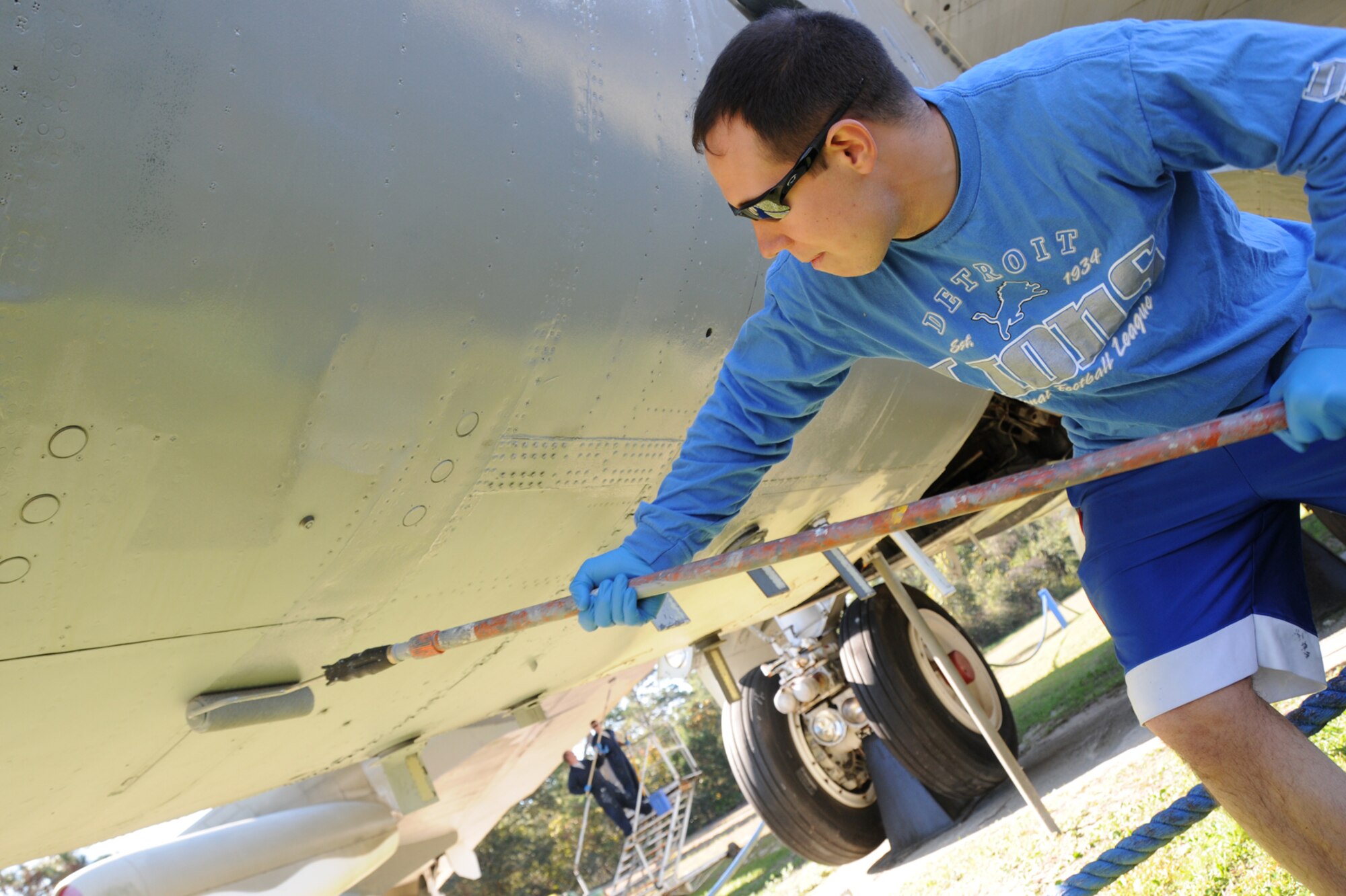 EGLIN AIR FORCE BASE, Fla. – Senior Airman Joshua Estep, 96th Security Forces Squadron investigations/antiterrorism officer, primes a B-52G static display at the Air Force Armament Museum Nov. 13. The 96th SFS and 96th Ground Combat Training Squadron are working together to fully restore the aging aircraft as part of the Adopt-a-Plane program which aims to have individual organizations take responsibility for maintaining a specific aircraft. (U.S. Air Force photo/ Airman 1st Class Anthony Jennings)