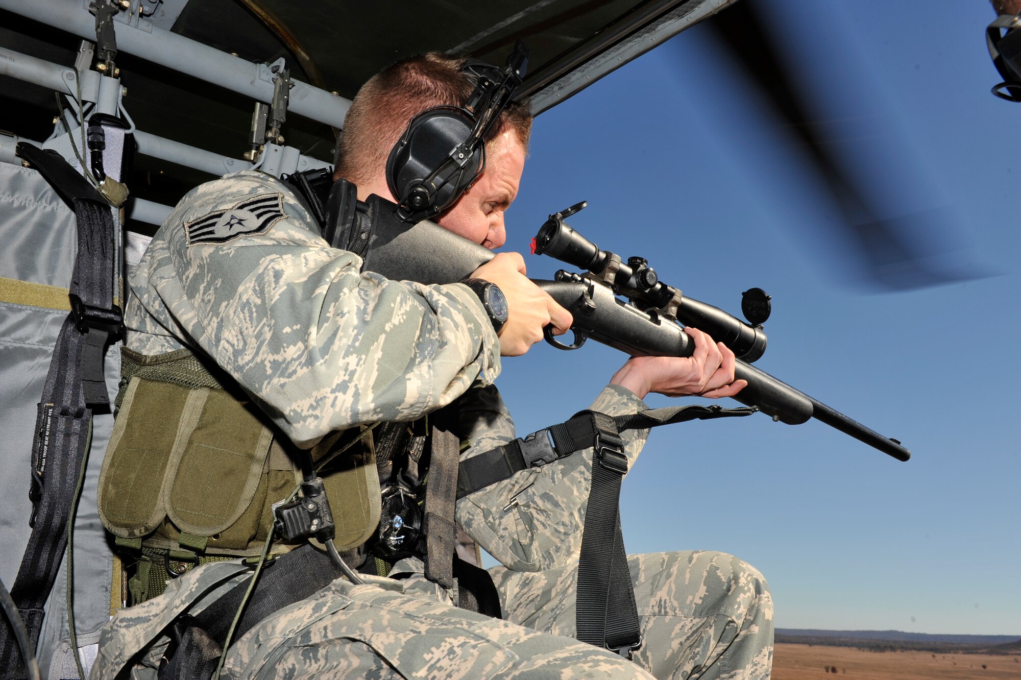 Staff Sgt. Carl Hook, 19th Security Forces Squadron security forces trainer and sharp shooter, takes aim at a target through his scope while in a Blackhawk helicopter at Fort Chaffee, Ark., Nov. 2. Sergeant Hook competed in the 2009 Inter-Service Sniper Sustainment Training Exercise from Nov. 7 to 13 at Fort Chaffee, Ark. (U.S. Air Force photo by Airman 1st Class Lausanne Pacheco)