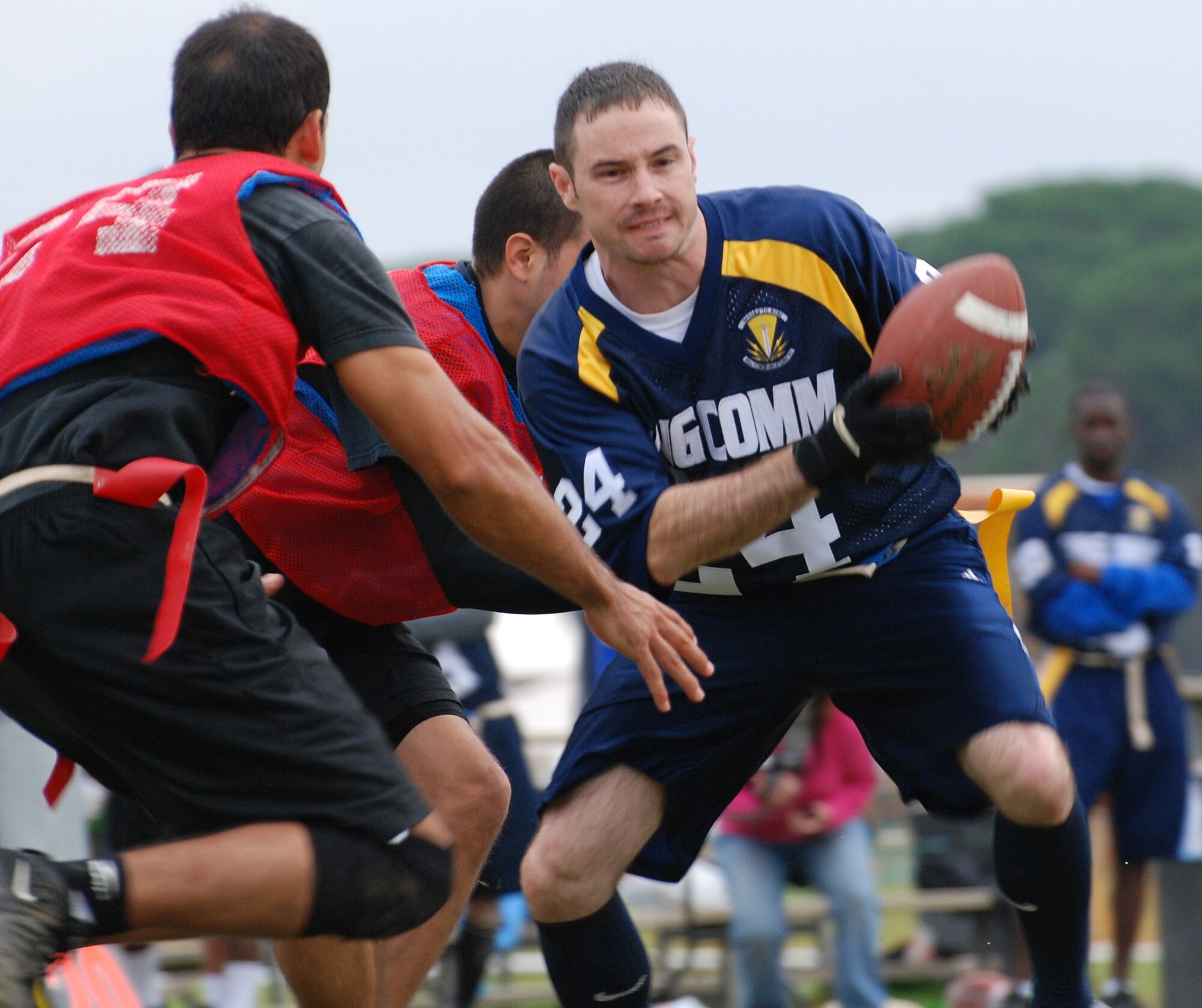 Team King Comm running back Blane Woodard runs the ball to pick up yardage during the U.S. Air Forces in Europe Flag Football Championship in Camp Darby, Italy, Nov. 12 through 16. The 86th Communications Squadron football team won the championship 20-19 in double overtime against the Camp Darby team. (Photo by Joyce Costello, courtesy of the U.S. Army)