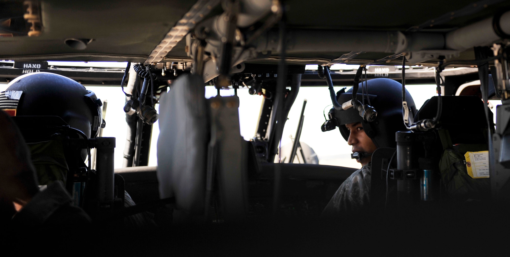 Chief Warrant Officer Tony Jordan, a Blackhawk helicopter pilot; and Capt. Patrick Hawkins, Camp Robinson medical evacuation commander, perform a pre-flight checklist before taking off in an Army Blackhawk on the flightline on base Nov 2. Chief Jordan and Captain Hawkins volunteered to aid 19th Security Forces Squadron in training for the sniper competition. (U.S. Air Force photo by Airman 1st Class Lausanne Pacheco)