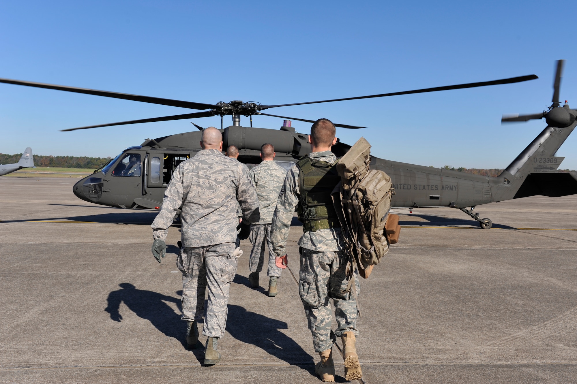 Members of the 19th Security Forces Squadron prepare to board a Blackhawk in preparation for sniper training at Fort Chaffee, Ark., Nov. 2. (U.S. Air Force photo by Airman 1st Class Lausanne Pacheco)