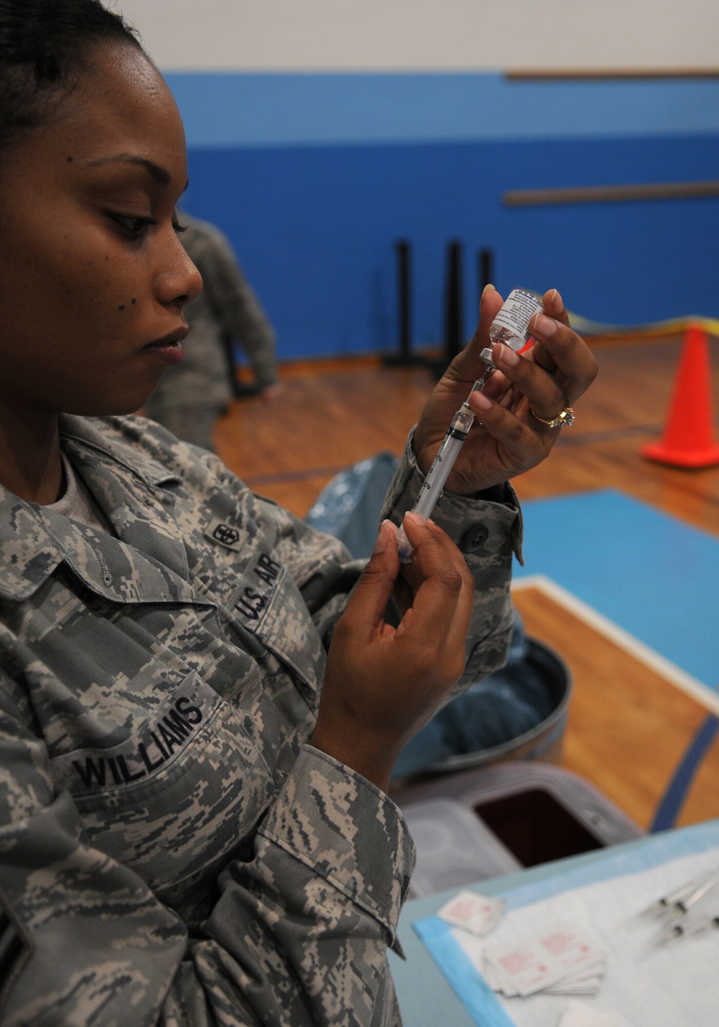 U.S. Air Force Senior Airman Sara Williams, 86th Aeromedical Squadron medical technician, prepares the H1N1 vaccine for administration at the Southside Gym Annex Ramstein Air Base, Germany, Nov. 17, 2009. The H1N1 vaccine is being given to military members and their families to help fight against influenza around the Kaiserslautern Military Community. (U.S. Air Force photo by Airman 1st Class Caleb Pierce)