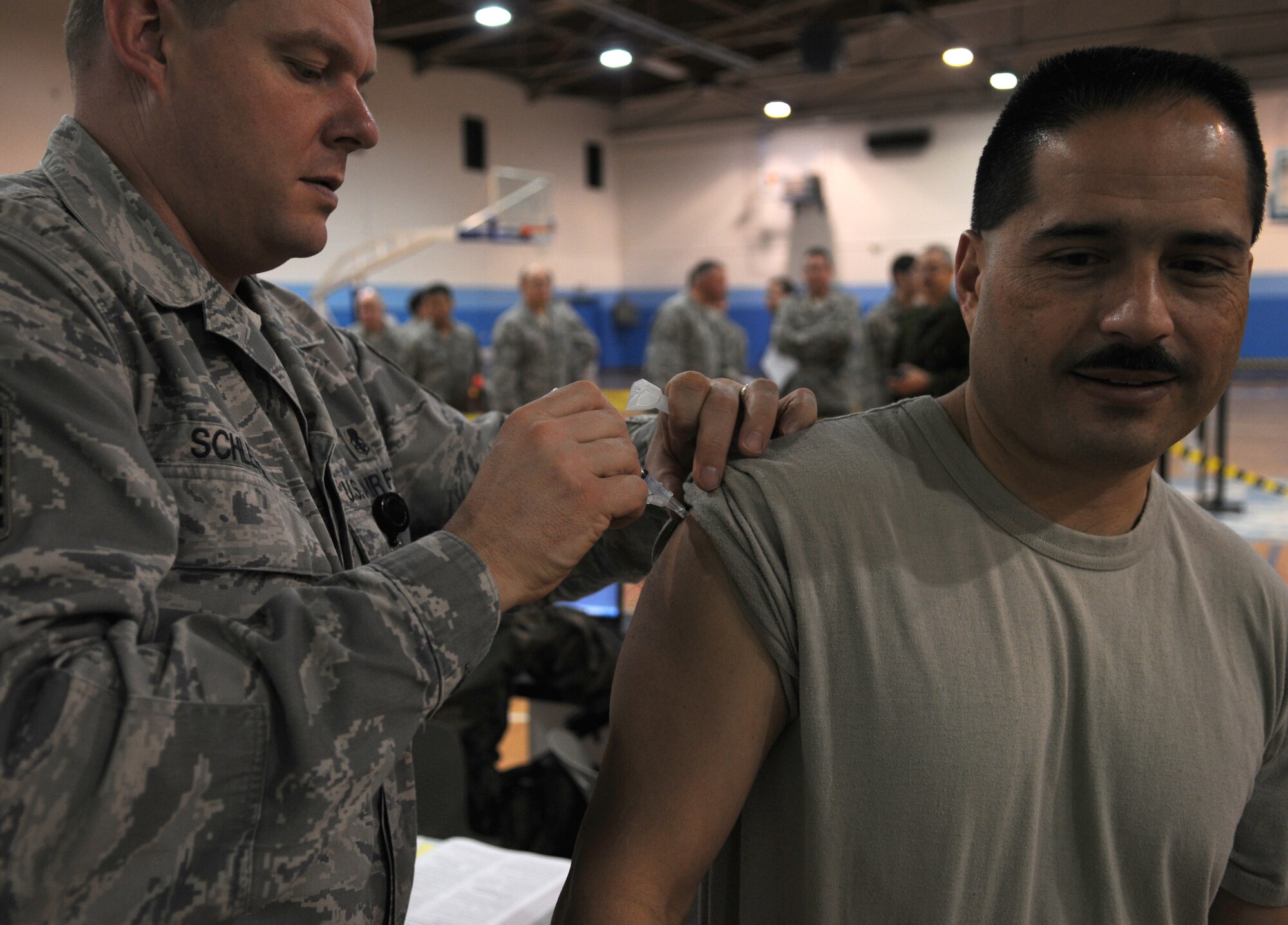 U.S. Air Force Master Sgt. Joseph Schleper, 86th Medical Operations Squadron medical technician, administers the H1N1 vaccine to Chief Master Sgt. Paul Clark, 86th Mission Support Group superintendent, at the Southside Gym Annex Ramstein Air Base, Germany, Nov. 17, 2009. The H1N1 vaccine is being given to military members and their families to help fight against influenza around the Kaiserslautern Military Community. (U.S. Air Force photo by Airman 1st Class Caleb Pierce)