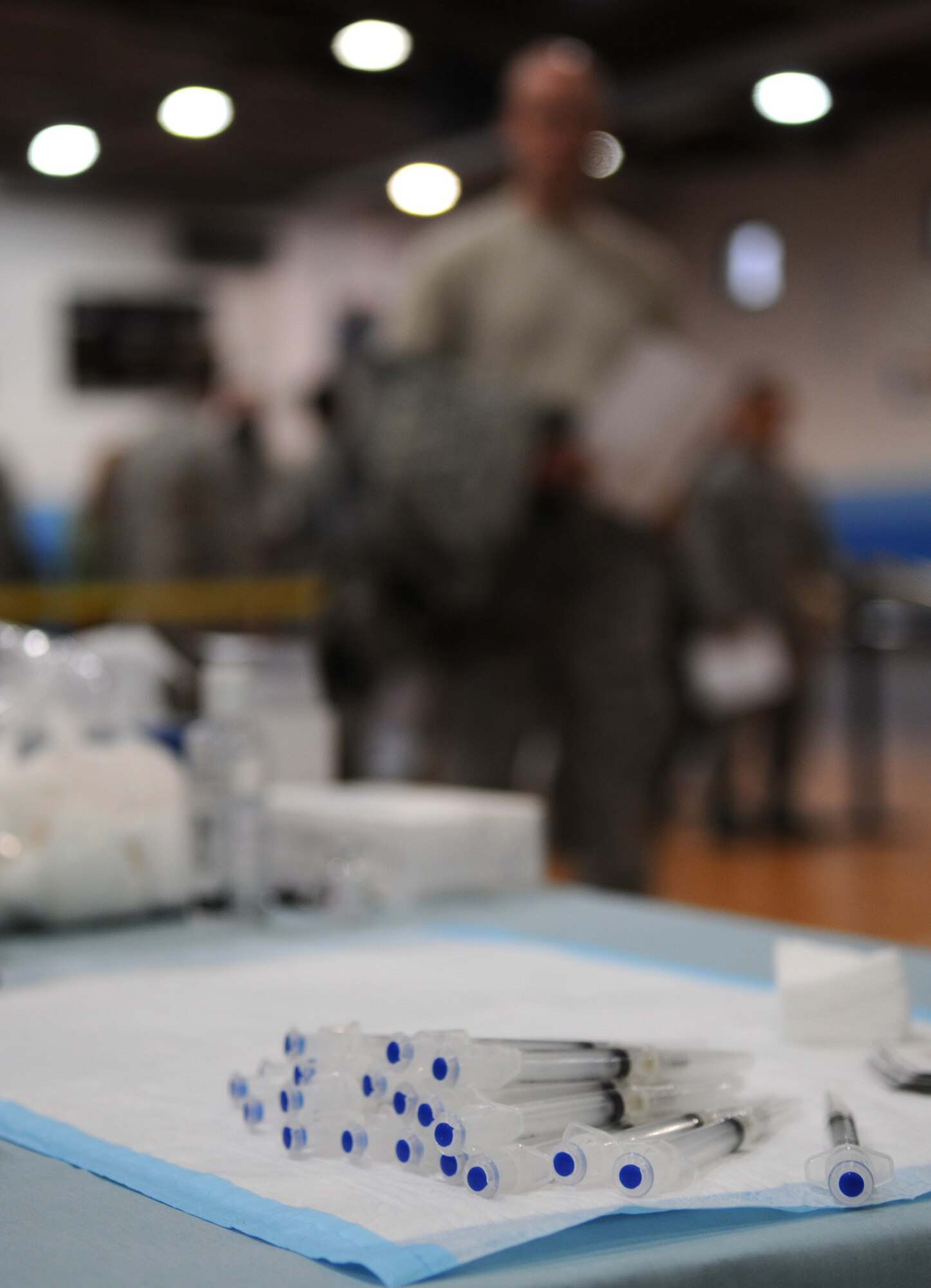 Military Members receive their H1N1 vaccine at Southside Gym Annex Ramstein Air Base, Germany, Nov. 17, 2009. The H1N1 vaccine is being given to military members and their families to help fight against influenza around the Kaiserslautern Military Community. The H1N1 virus is commonly spread from person to person through coughing and sneezing.  You can also become infected by touching something with the flu virus on it and then touching your nose or mouth.  The virus can survive and infect a person for up to 2-8 hours after being deposited on a surface. (U.S. Air Force photo by Airman 1st Class Caleb Pierce)