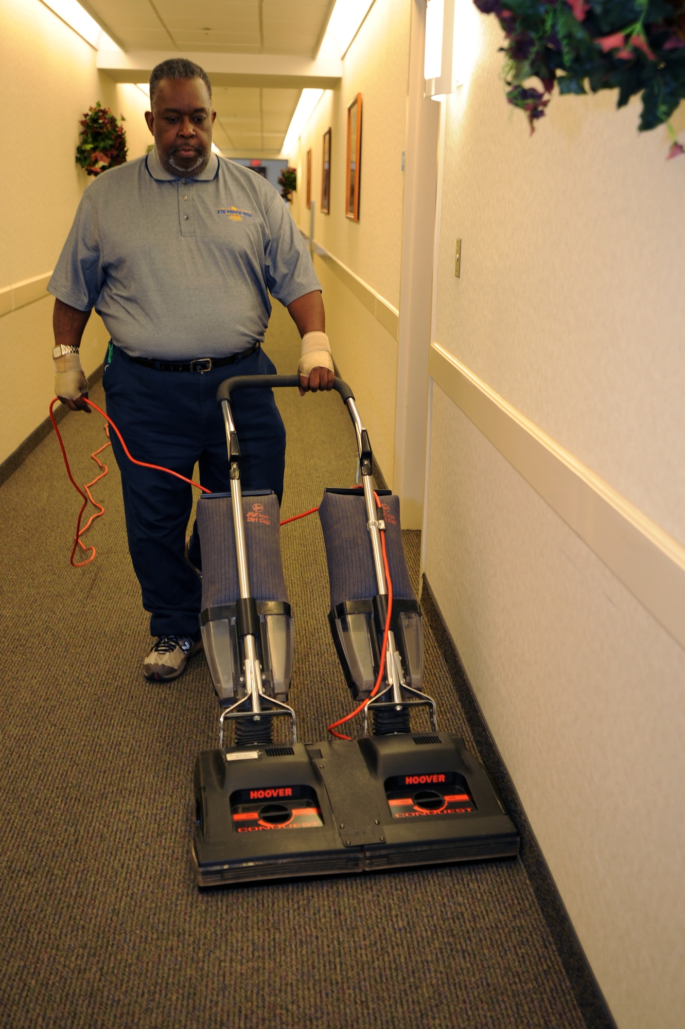 Jerome Clark, 19th Force Support Squadron custodial worker, vacuums the carpets at the Temporary Lodging Facility Nov. 12. (U.S. Air Force photo by Senior Airman Jim Araos)