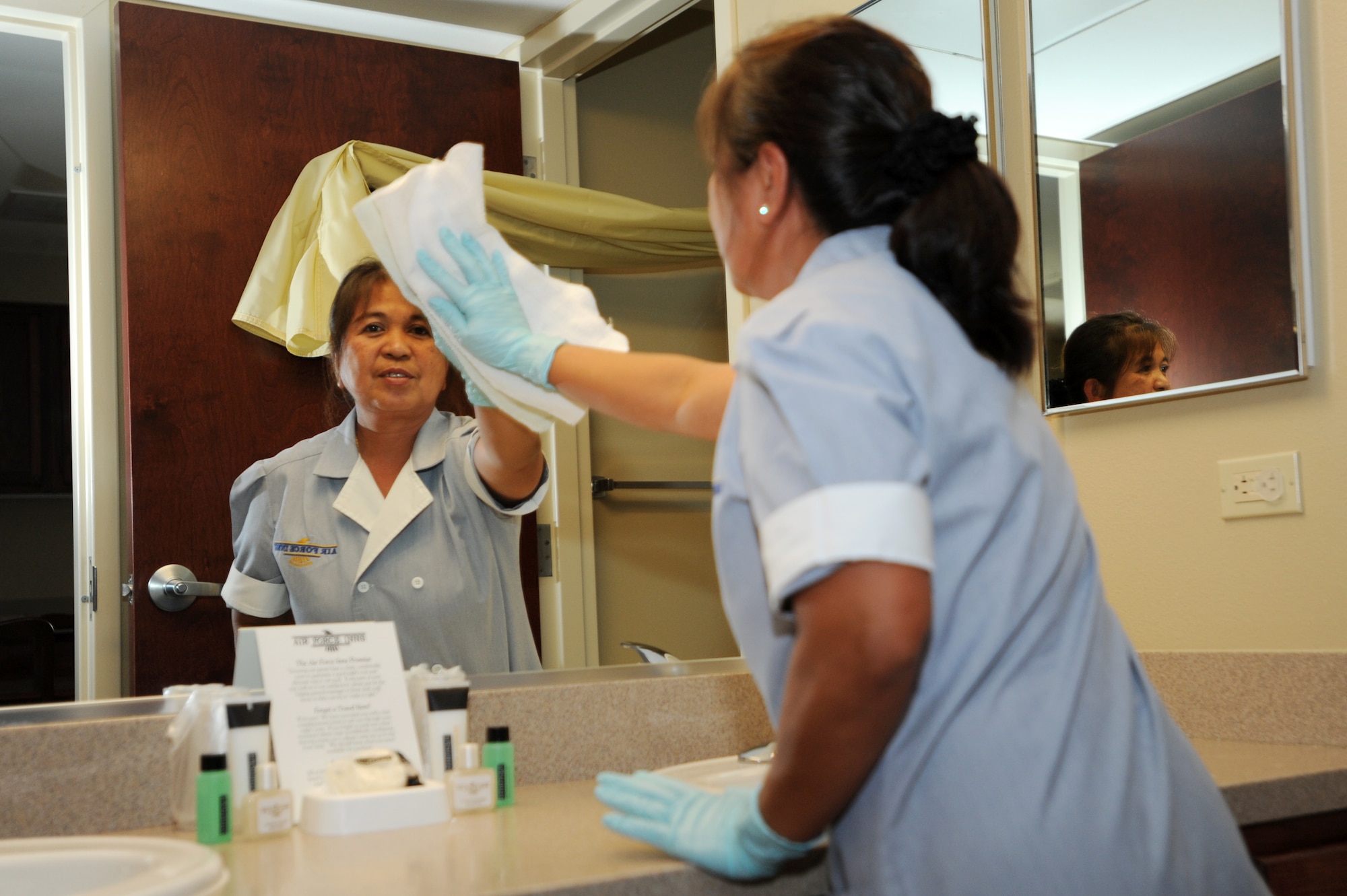 Alice Williams, 19th Force Support Squadron custodial worker, cleans a guest room mirror at the Temporary Lodging Facility Nov. 12. (U.S. Air Force photo by Senior Airman Jim Araos)
