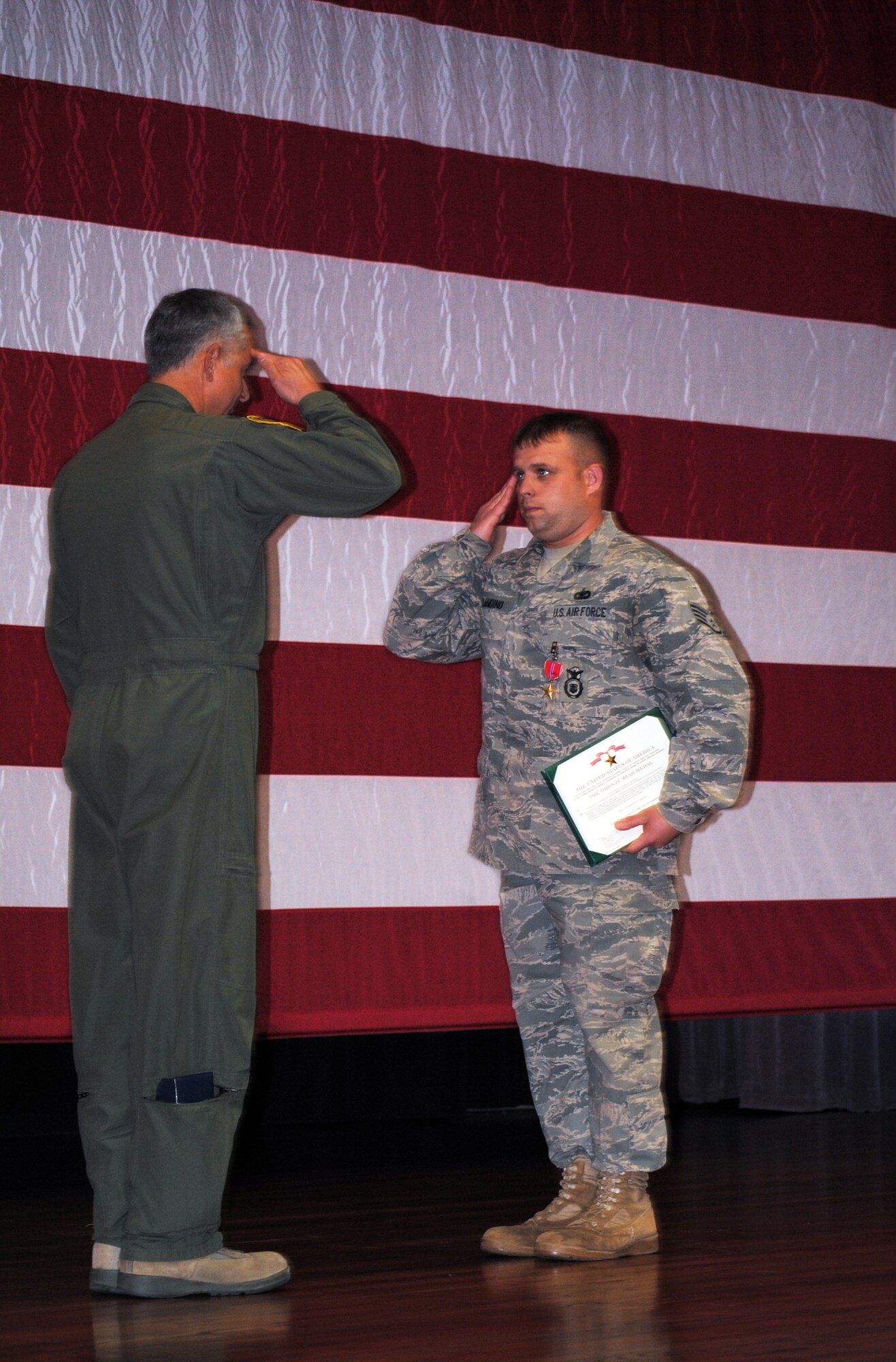 Col. Roger Watkins, 14th Flying Training Wing commander, presents the Bronze Star to Staff Sgt. Thomas Blandino, a military working dog handler with the 14th Security Forces Squadron Nov. 12 at the Columbus Air Force Base Kaye Auditorium. Sergeant Blandino was awarded the Bronze Star by the U.S. Army for his actions while serving with them. (U.S. Air Force photo/Senior Airman Jacob Corbin). 