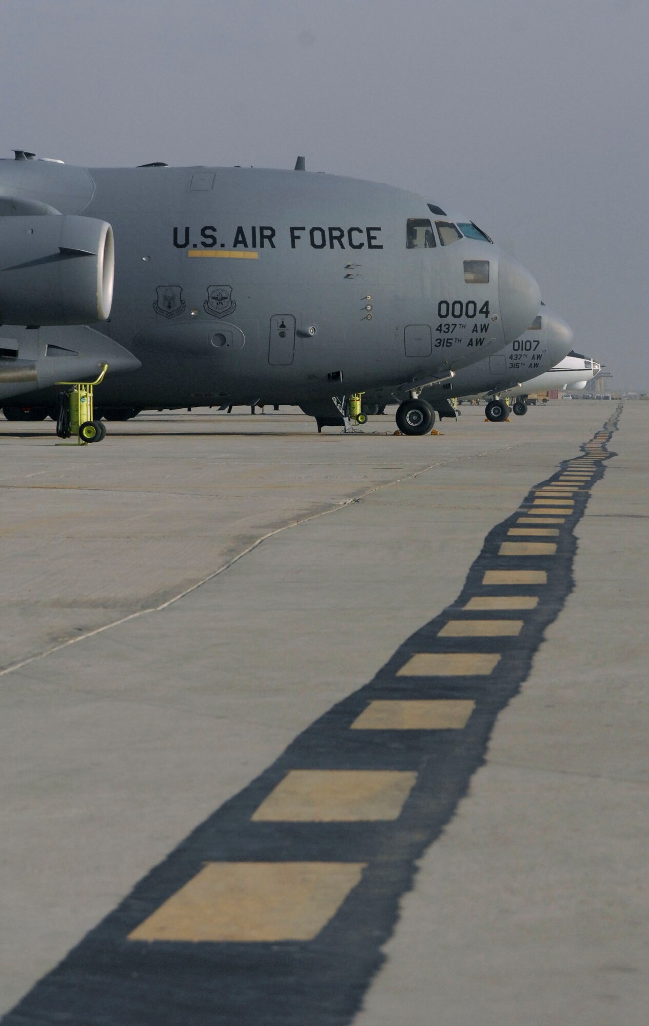 BAGRAM AIRFIELD, Afghanistan -- Two C-17 Globermaster III's wait on the runway Nov. 17, 2009 for their next mission. C-17's are primarily used to transport cargo and troops, and can carry a maximum of 170,900 pounds, and can land on runways as short as 3,500 feet, which is crucial to resupplying Afghanistan operations from the air or on the ground in remote areas. . (U.S. Air Force photo/Senior Airman Susan Tracy)