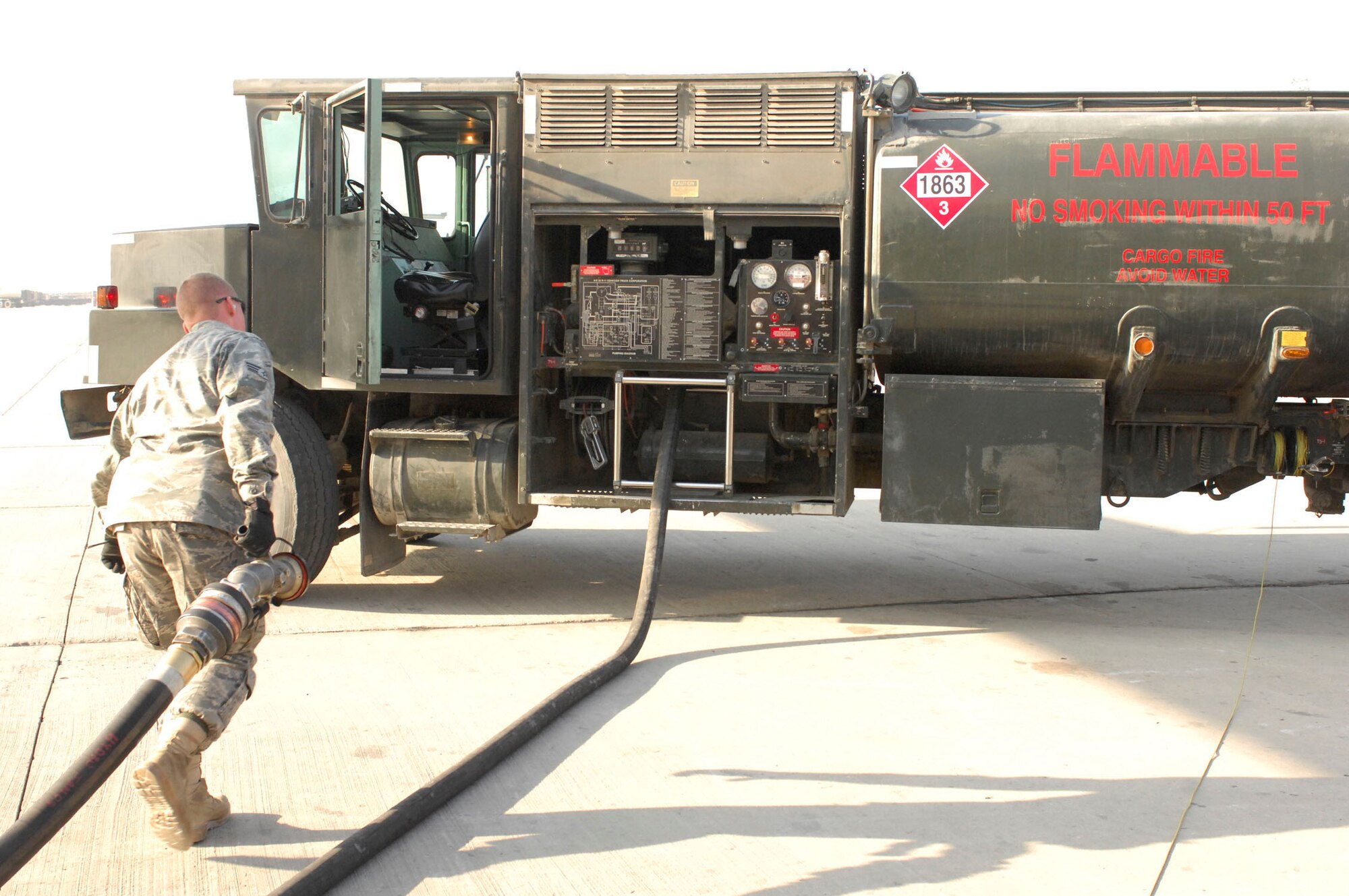 BAGRAM AIRFIELD, Afghanistan -- Senior Airman Jacob Barnes, a fuels journeyman from the 455th Expeditionary Logistics Readiness Squadron, drags a hose back to his truck after fueling a C-17 Globemaster III waiting to load cargo for troops in the field, Nov. 17, 2009. Airman Barnes is from Detroit, Mich., and is deployed from Andersen Air Force Base, Guam. (U.S. Air Force photo/Senior Airman Susan Tracy)
