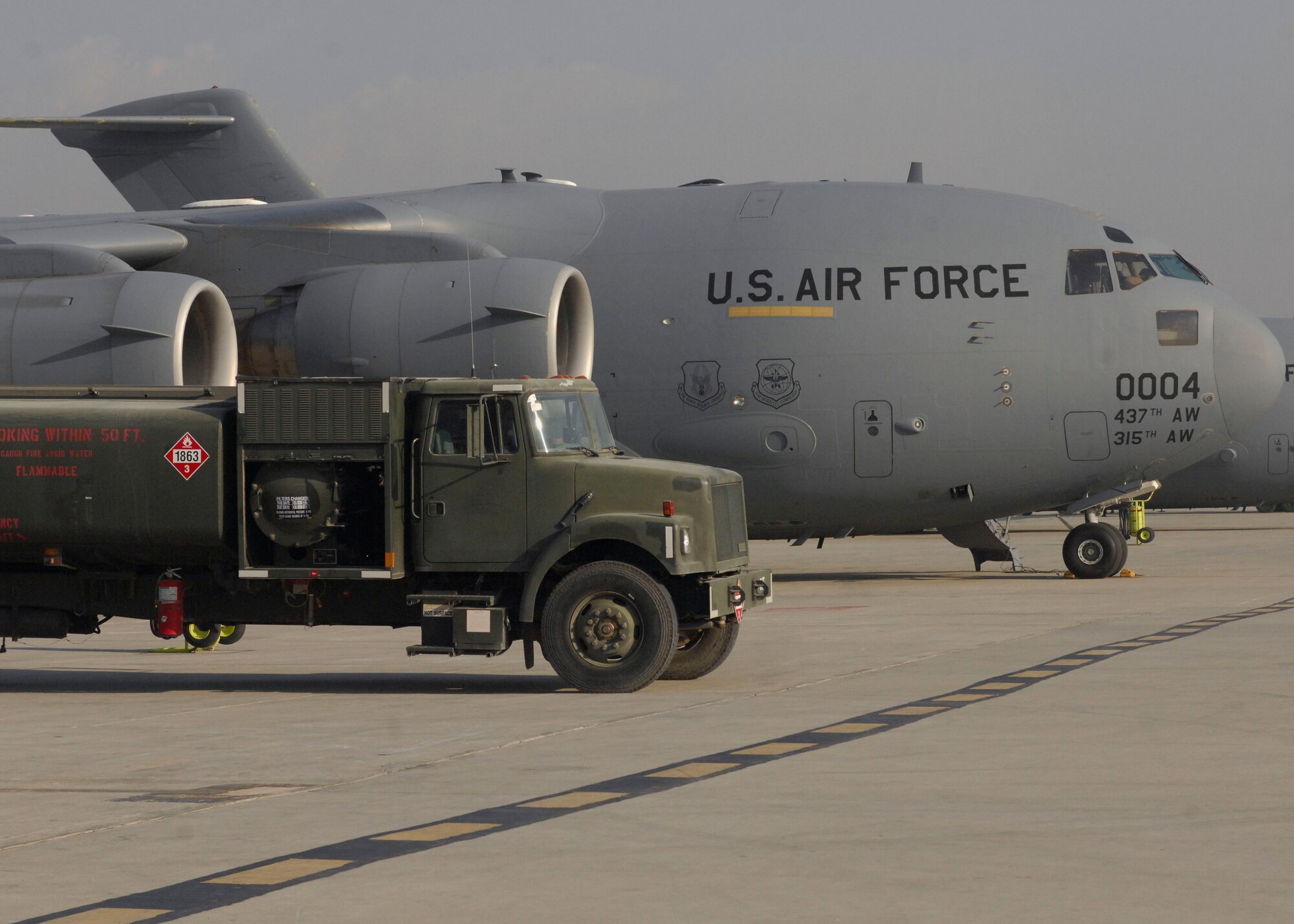 BAGRAM AIRFIELD, Afghanistan -- Two C-17 Globermaster III's wait on the runway Nov. 17, 2009 for their next mission. C-17's are primarily used to transport cargo and troops, and can carry a maximum of 170,900 pounds, and can land on runways as short as 3,500 feet, which is crucial to resupplying Afghanistan operations from the air or on the ground in remote areas. (U.S. Air Force photo/Senior Airman Susan Tracy)