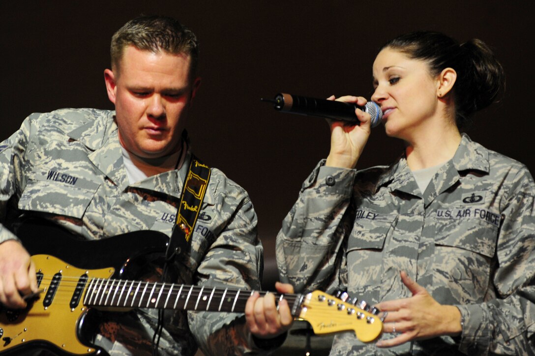 TRANSIT CENTER AT MANAS, Kyrgyzstan -- Tech. Sgts. Steve Wilson and Christin Foley, U.S. Air Forces Central Sirocco Band artists, perform during a show at Pete's Place, Nov. 15, 2009. The Sirocco Band members perform rock, oldies, pop, and country music. (U.S. Air Force photo/Senior Airman Steele C. G. Britton)