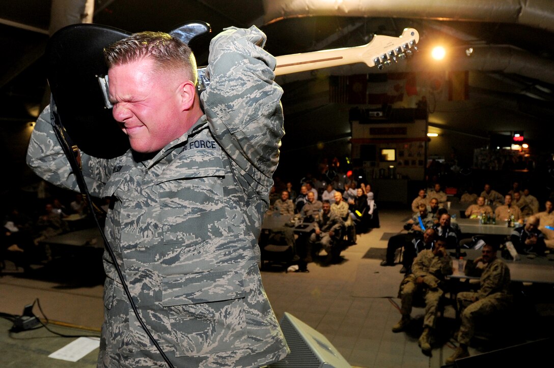 TRANSIT CENTER AT MANAS, Kyrgyzstan -- Tech. Sgt. Steve Wilson, U.S. Air Forces Central Sirocco Band guitarist, performs a solo during a show at Pete's Place, Nov. 15, 2009. The Sirocco Band made their fourth performance in Kyrgyzstan at the Transit Center. They perform a wide variety of music including rock, oldies, country, and pop. Sirocco members are deployed from Lackland Air Force Base, Texas. (U.S. Air Force photo/Senior Airman Steele C. G. Britton)