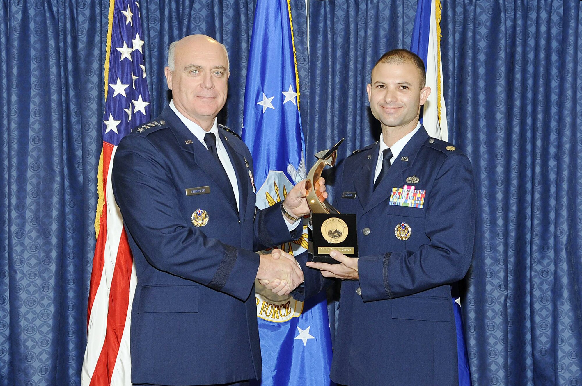 Gen. Carrol H. "Howie" Chandler presents the Gen. Lew Allen Jr. Award to Maj. Eliot A. Sasson Nov. 16, 2009, in the Airman's Hall of the Pentagon. General Chandler is the vice chief of staff of the Air Force. Major Sasson is an operations officer with the 437th Aircraft Maintenance Squadron at Charleston Air Force Base, S.C. (U.S. Air Force photo)