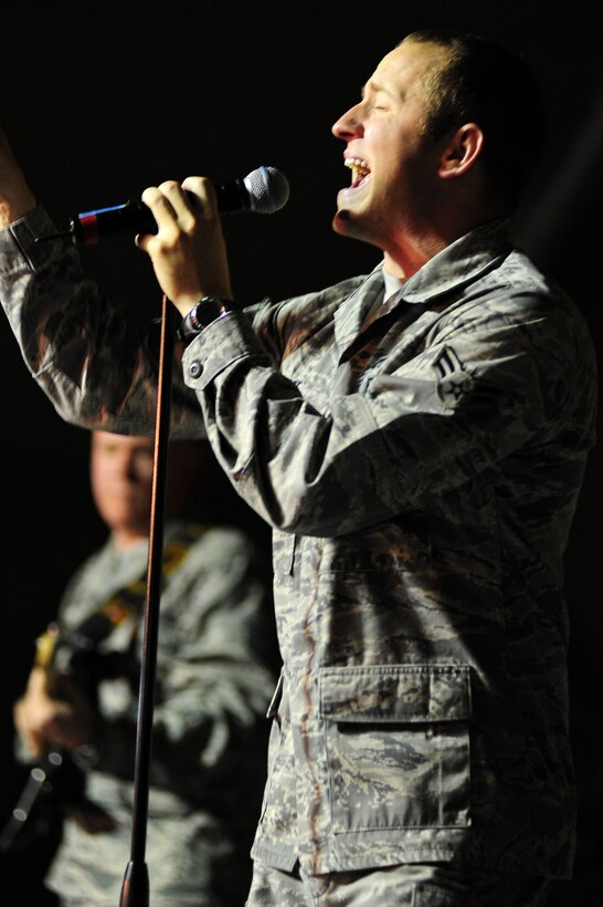 TRANSIT CENTER AT MANAS, Kyrgyzstan -- Airman 1st Class Clayton Lee, U.S. Air Forces Central Sirocco Band vocalist, performs a Justin Timberlake hit during a performance at Pete's Place, Nov. 15, 2009. The Sirocco Band made their fourth performance in Kyrgyzstan at the Transit Center. They perform a wide variety of music including rock, oldies, country, and pop. Sirocco members are deployed from Lackland Air Force Base, Texas. (U.S. Air Force photo/Senior Airman Steele C. G. Britton)