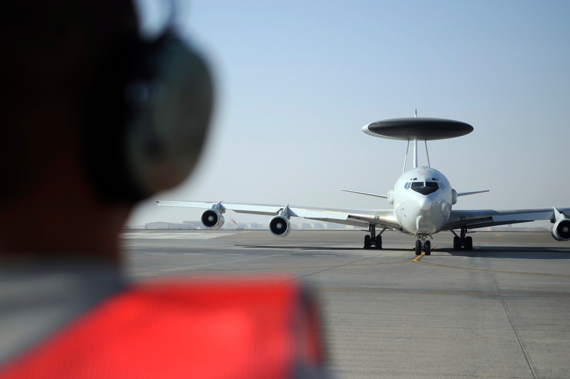 SOUTHWEST ASIA - Staff Sgt. Justin Butler, 380 Expeditionary Aircraft Maintenance Squadron, marshals an E-3 Sentry Nov. 16, 2009. Sergeant Butler is deployed from Tinker Air Force Base, Okla., and hails from Olivehurst, Calif. (U.S. Air Force photo/Senior Airman Stephen Linch)