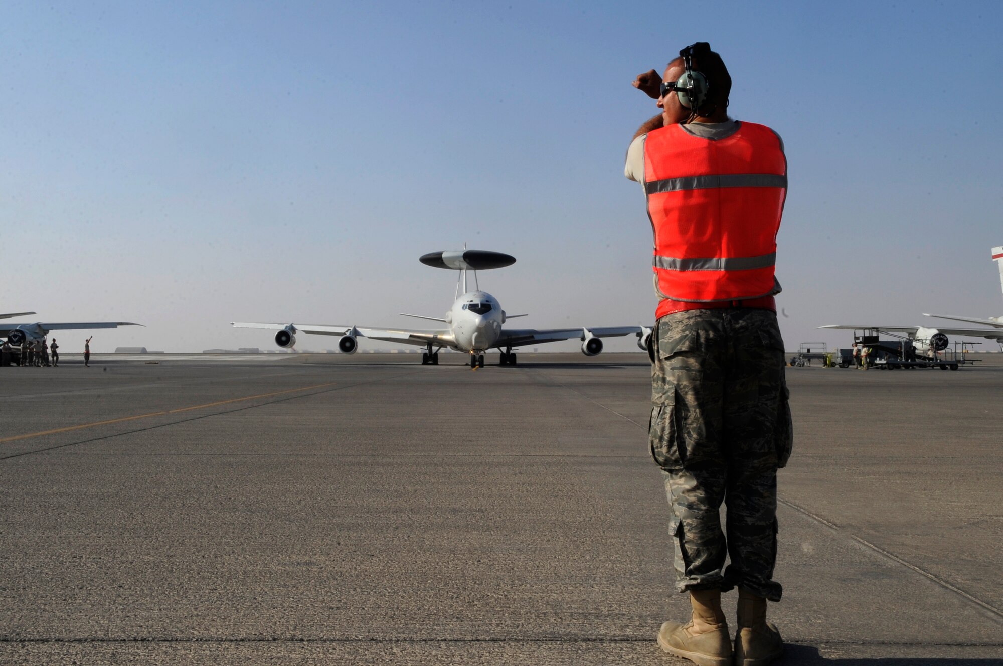 SOUTHWEST ASIA - Staff Sgt. Justin Butler, 380th Expeditionary Aircraft Maintenance Squadron, marshals an E-3 Sentry, before it taxis to take-off in support of Operation Enduring Freedom Nov. 16, 2009. Sergeant Butler is deployed from Tinker Air Force Base, Okla., and hails from Olivehurst, Calif. (U.S. Air Force photo/Senior Airman Stephen Linch)