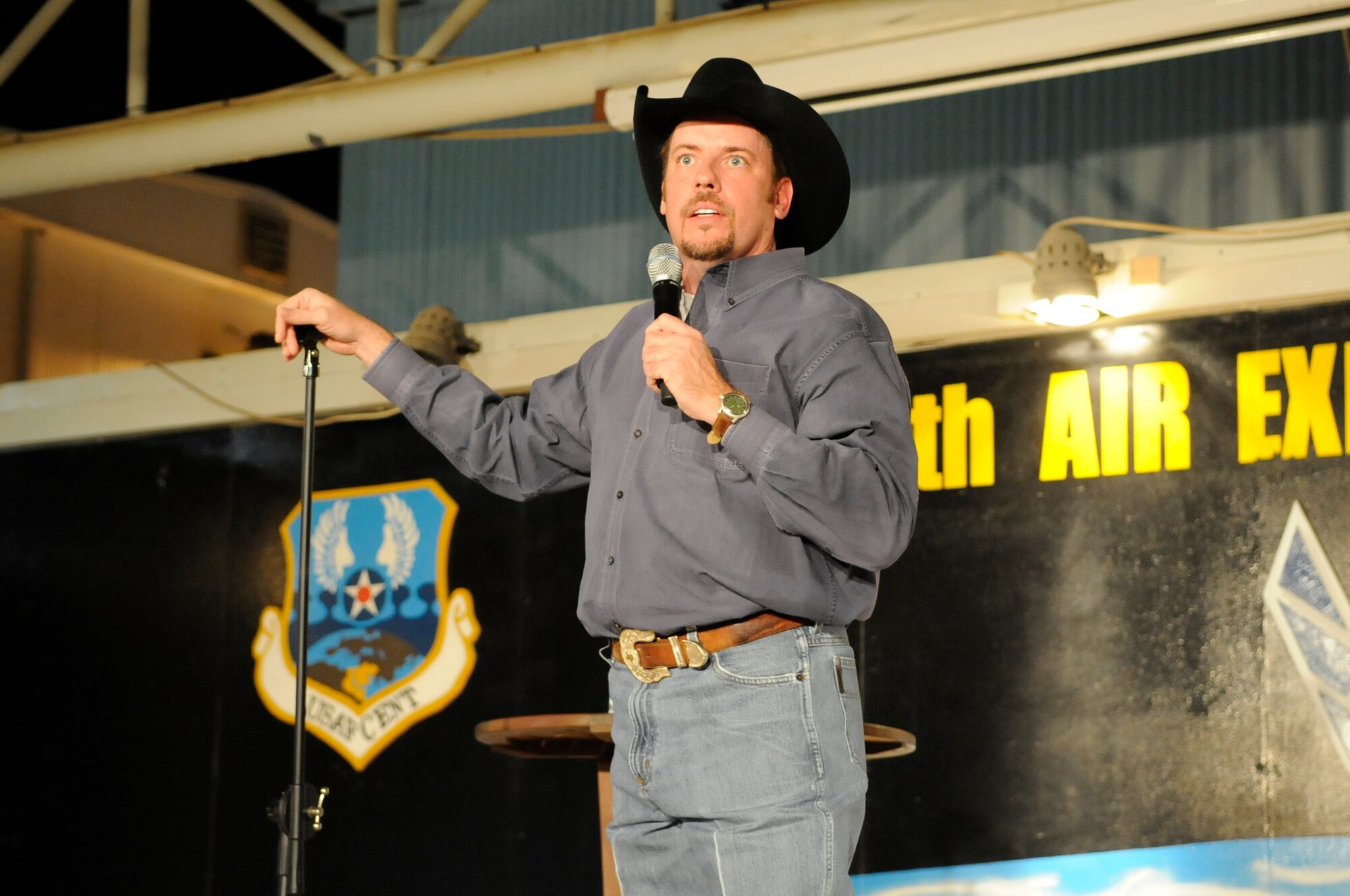 SOUTHWEST ASIA - Cowboy Bill Martin, stand-up comedian, performs his comedy routine to an audience of Airmen and Soldiers at the 380th Air Expeditionary Wing Nov. 16, 2009. The "Red, White and A Little Bluer" tour was presented by Armed Forces Entertainment and is composed of stand-up comedians Cowboy Bill Martin, Dan Davidson and Justin Leon. (U.S. Air Force photo/Senior Airman Stephen Linch)
