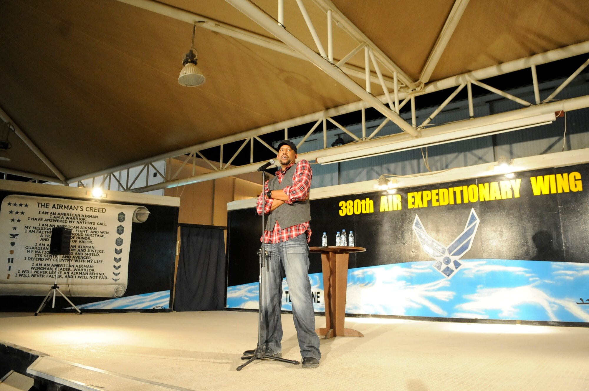 SOUTHWEST ASIA - Justin Leon, a stand-up comedian from Kansas City, Mo., performs his comedy routine to an audience of Airmen and Soldiers at the 380th Air Expeditionary Wing Nov. 16, 2009. The "Red, White and A Little Bluer" tour was presented by Armed Forces Entertainment and is composed of stand-up comedians Cowboy Bill Martin, Dan Davidson and Justin Leon. (U.S. Air Force photo/Senior Airman Stephen Linch)
