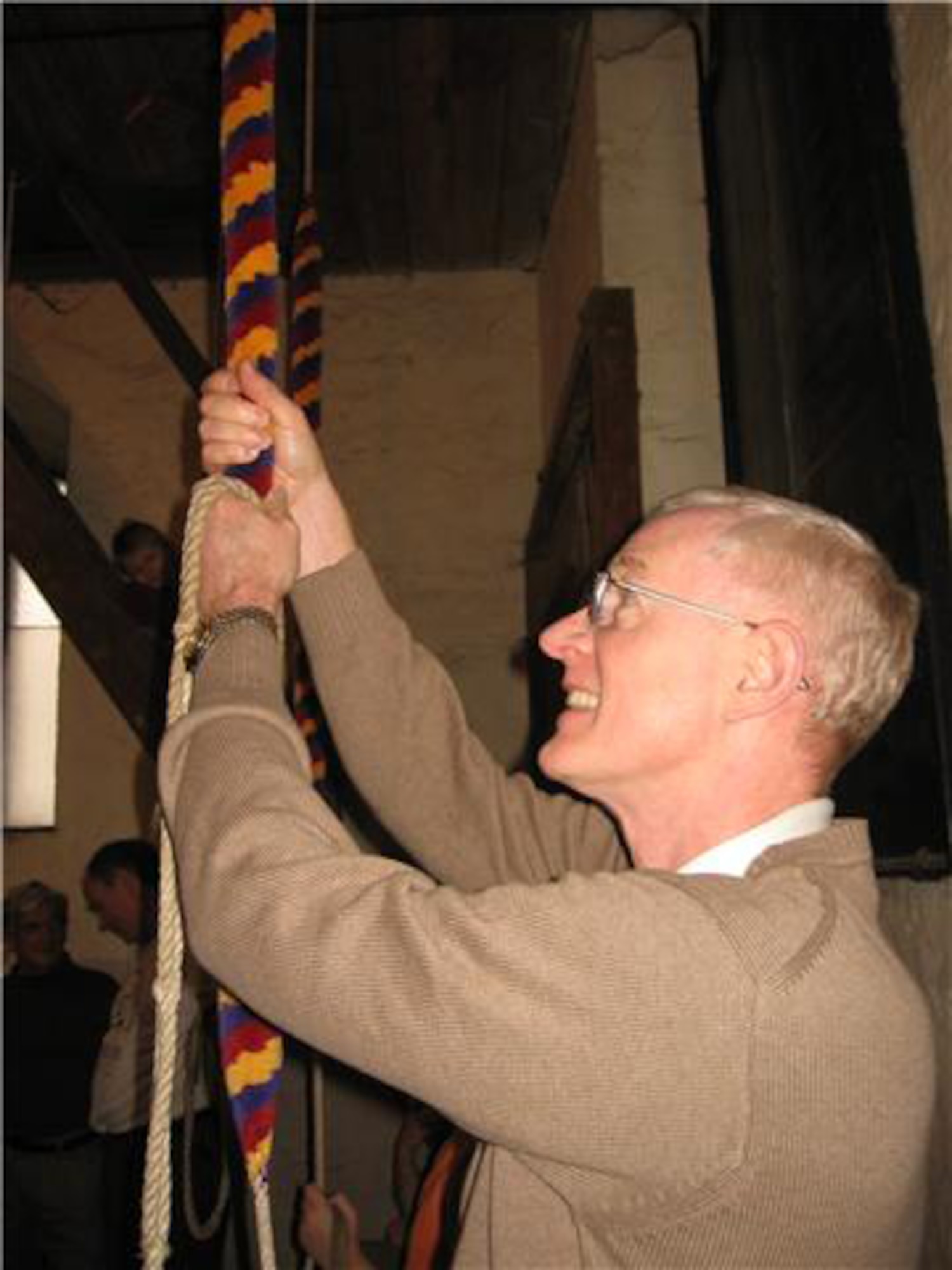 Dr. Robert Allen, 352nd Special Operations Group historian, takes a swing at ringing the bells in a local Church of England village church. Most of the local village churches were built in the 1400s, and most had a set of bells.  By the 1700s, bands of bell ringers had developed various patterns that could be rung on their church bells. (U.S. Air Force photo) 