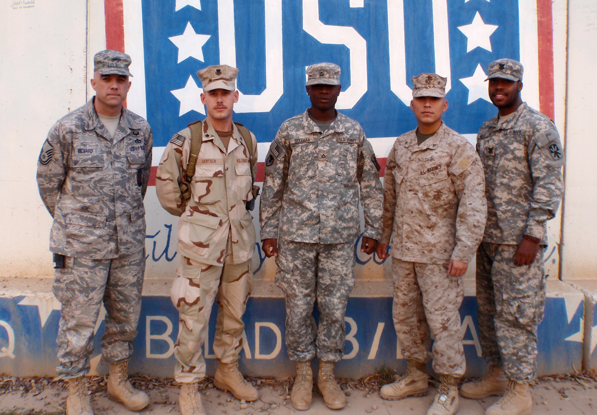 JOINT BASE BALAD, Iraq -- On Nov. 13, 2009, staffers at the United Service Organizations chapter noticed, for the first time in their memory, that all five services were represented in the building. To commemorate the rare occasion, they arranged a photo opportunity. From left are Air Force Master Sgt. Tim Rickard of Denver, Co., Coast Guard Petty Officer 2nd Class Pete Gertsch of Essex, Mass., Army Pfc. Noah Coleman of Summerville, S.C., Marines Lance Cpl. Jesse Mendez of Houston, Texas, and Navy Petty Officer 2nd Class Julius Adams of Philadelphia, Pa. (Courtesy photo)