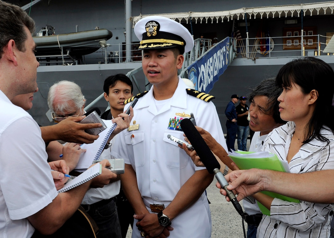 Navy Cmdr. H.B. Le, commanding officer of the guided-missile destroyer USS Lassen, speaks to reporters in front of the U.S. 7th Fleet command ship USS Blue Ridge in Da Nang, Vietnam, Nov. 7, 2009. It was Le's first visit to Vietnam after leaving the country with his family in 1975. U.S. Navy photo by Petty Officer 2nd Class Cynthia Griggs  