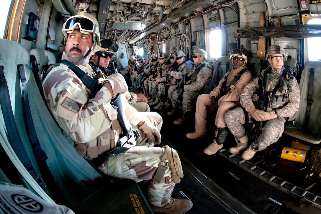 An Iraqi scout looks out the window of a helicopter during joint air assault training for Iraqi troops and U.S. Army paratroopers on Camp Ramadi, Iraq, Nov. 15, 2009. The U.S. soldiers are assigned to the 82nd Airborne Division's 2nd Battalion, 504th Parachute Infantry Regiment, which is serving as an Advise and Assist Brigade.