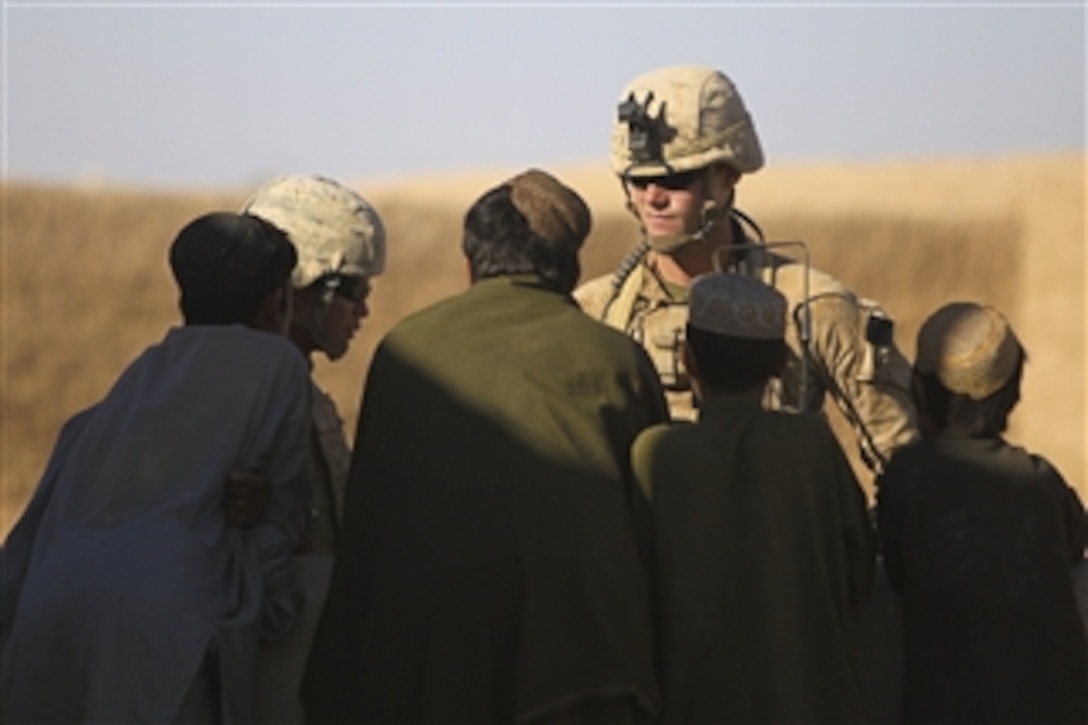 U.S. Marine Corps Lt. John Schippert, platoon commander of Combined Anti-Armor Team 2, 1st Battalion, 5th Marine Regiment, and an interpreter talk to Afghan children while conducting a security patrol in the Nawa district of the Helmand province, Afghanistan, on Nov. 9, 2009.  The 1st Battalion, 5th Marine Regiment is a ground combat element deployed with Regimental Combat Team 7, which conducts counterinsurgency operations in partnership with Afghan National Security Forces in southern Afghanistan.  