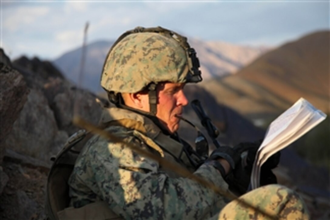 U.S. Marine Sgt. Samuel Barnes, assigned to Embedded Training Team 1-12th, reads his map to discern his location during a security halt while on patrol across the Depak Valley, Afghanistan, on Oct. 30, 2009.  Barnes is on patrol with Afghan National Army soldiers, and U.S. Army soldiers.  