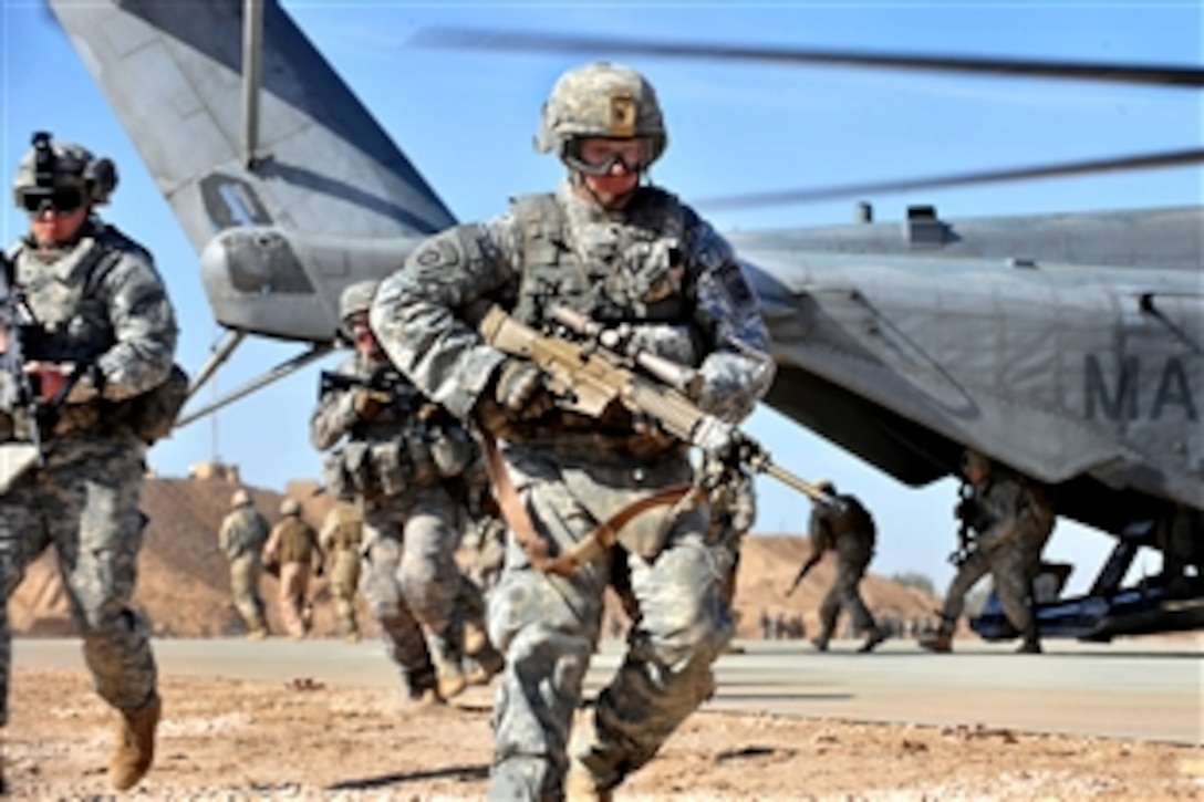 A U.S. soldier runs to provide security after unloading from a CH-53 Sea Stallion during an exercise on Camp Ramadi in western Iraq, Nov. 15, 2009. U.S. Marines, and U.S. and Iraqi soldiers train together on the Sea Stallion to prepare for upcoming missions. The soldiers are assigned to the 82nd Airborne Division's 2nd Battalion, 504th Parachute Infantry Regiment, 1st Brigade Combat Team.

