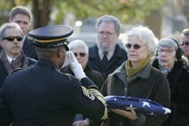 NEW YORK -- Roberta Eaton, Marine veteran and part of the Women Marines Association, watches the grave-side ceremony for the formerly oldest living female Marine, Miriam Cohen, who was buried Nov. 17, in Cypress Hills National Cemetery. The 101-year-old Cohen enlisted in the Marine Corps during World War II and again during the Korean War. She was the oldest female enlistee of her time at 35 years old and was part of the first female Marine recruit class. (Official Marine Corps photo by Sgt. Randall A. Clinton)