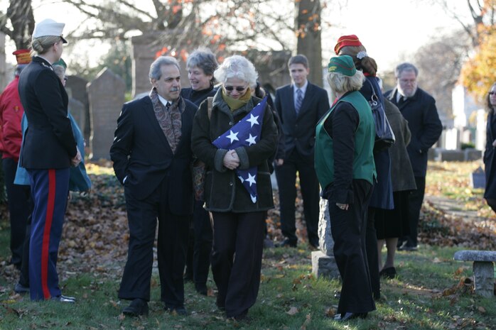 NEW YORK -- Debra Allee, niece of the formerly oldest living female Marine, Miriam Cohen, who was buried Nov. 17, in Cypress Hills National Cemetery, walks past a group of active duty Marines and Marine veterans after a grave-side service in memory of Cohen. The 101-year-old Cohen enlisted in the Marine Corps during World War II and again during the Korean War. She was the oldest female enlistee of her time at 35 years old and was part of the first female Marine recruit class. (Official Marine Corps photo by Sgt. Randall A. Clinton)