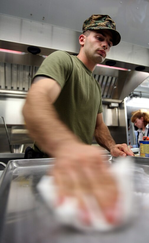 Sgt. Lee R. McCurdy, a food specialist with Camp Lejeune Base Food Service, prepares food during the week-long test of the Expeditionary Feeding Kitchen aboard Camp Lejeune, N.C., November 18, 2009. The new self-contained system is an improvement from the older Field Food Service System and can be constructed and ready to use in approximately 45 minutes.