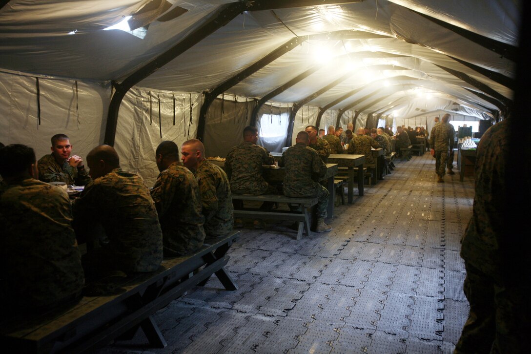 Marines and sailors enjoy meals during the week-long test of the new Expeditionary Feeding Kitchen aboard Camp Lejeune, N.C., November 18, 2009. The Expeditionary Feeding Kitchen produced enough food for 500 troops to eat during every meal of the day.