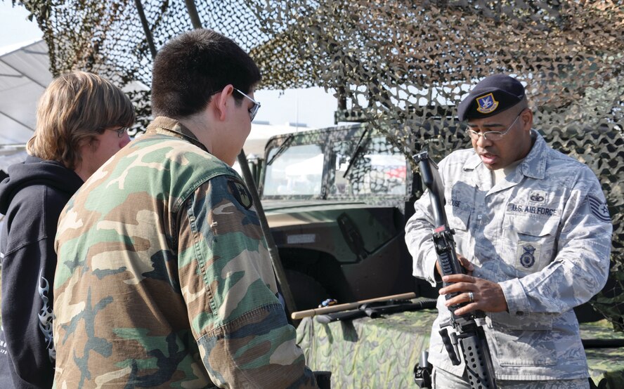 Tech. Sgt. David House talks about the M-240B with two young men who attended the veteran’s celebration at Flabob Airport in Riverside Nov. 7.  Staff Sgt. Hardy, Tech. Sgt. Warman, Tech. Sgt. Hill and Tech. Sgt. House volunteered to bring equipment from March to display at the event, which honored all veterans, from all wars, in all services. (U.S. Air Force photo by Capt. Mary Guest)