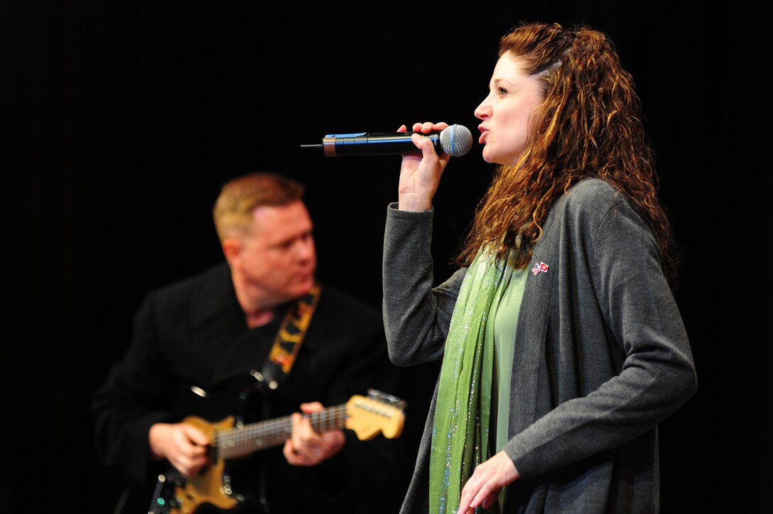 BISHKEK, Kyrgyzstan -- Tech. Sgt. Christin Foley, U.S. Air Forces Central Sirocco Band vocalist, performs with Tech. Sgt. Steve Wilson, U.S. AFCENT Sirocco Band guitarist, during a show at the Palace of Sport, Nov. 16, 2009. The Sirocco Band performs a wide variety of pop, oldies, and rock music. (U.S. Air Force photo/Senior Airman Steele C. G. Britton)