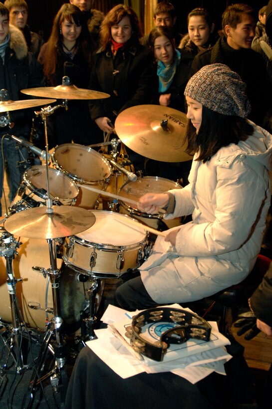 BISHKEK, Kyrgyzstan -- An audience member shows her talent on the drums following a performance by the U.S. Air Forces Central Sirocco Band at the Palace of Sport, Nov. 16, 2009. (U.S. Air Force photo/Senior Master Sgt. Andrew E. Lynch)