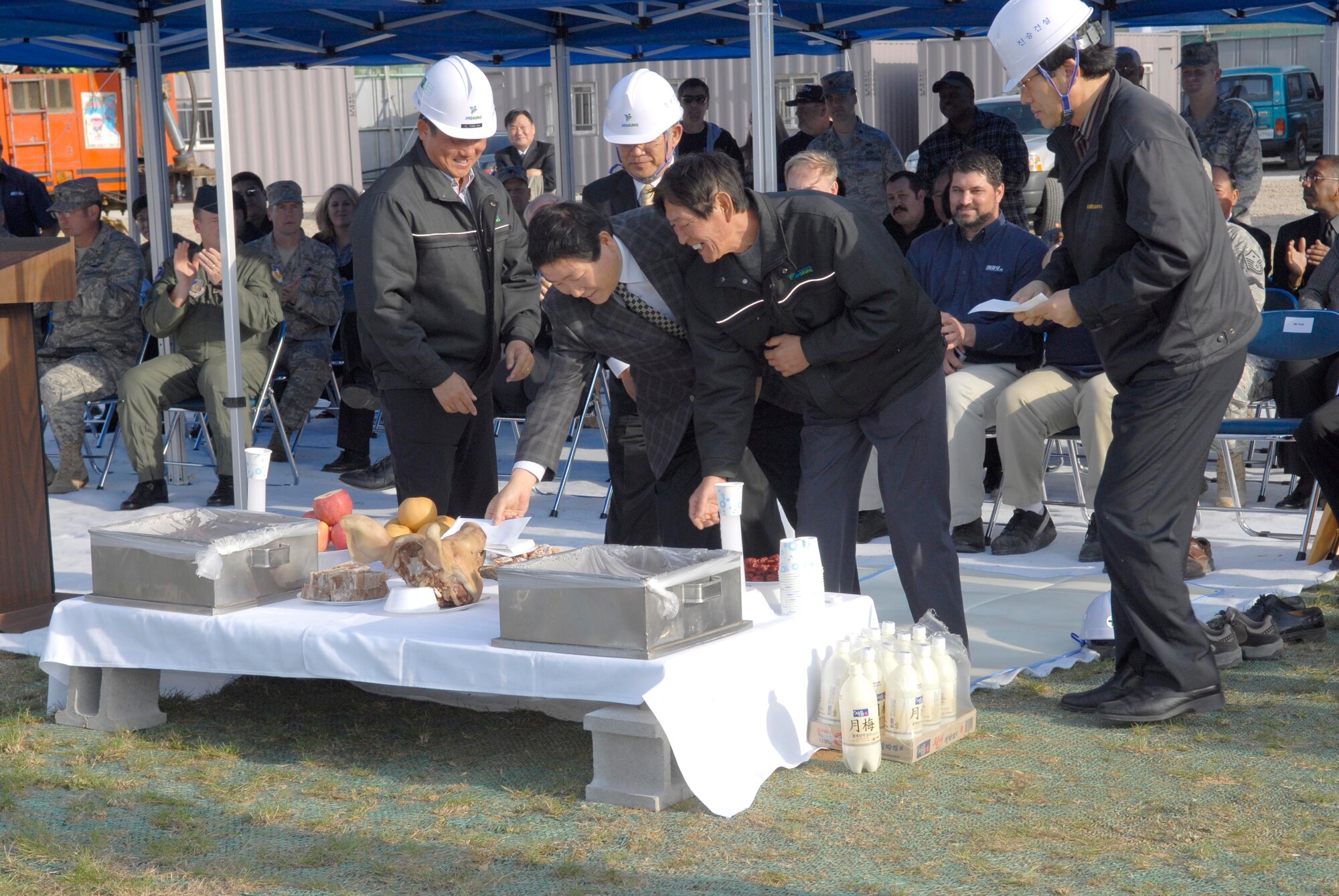 Construction crew members participate in a traditional blessing ceremony at the site of Osan Air Base's new enlisted club. According to officials, this will be the last exclusively enlisted club to be built in the Air Force. All new projects will be consolidated with separate space designated for officers and enlisted personnel. The construction is projected to last 22 months and will cost $17 million to complete. (U.S. Air Force photo/Master Sgt. Marlin Zimmerman)