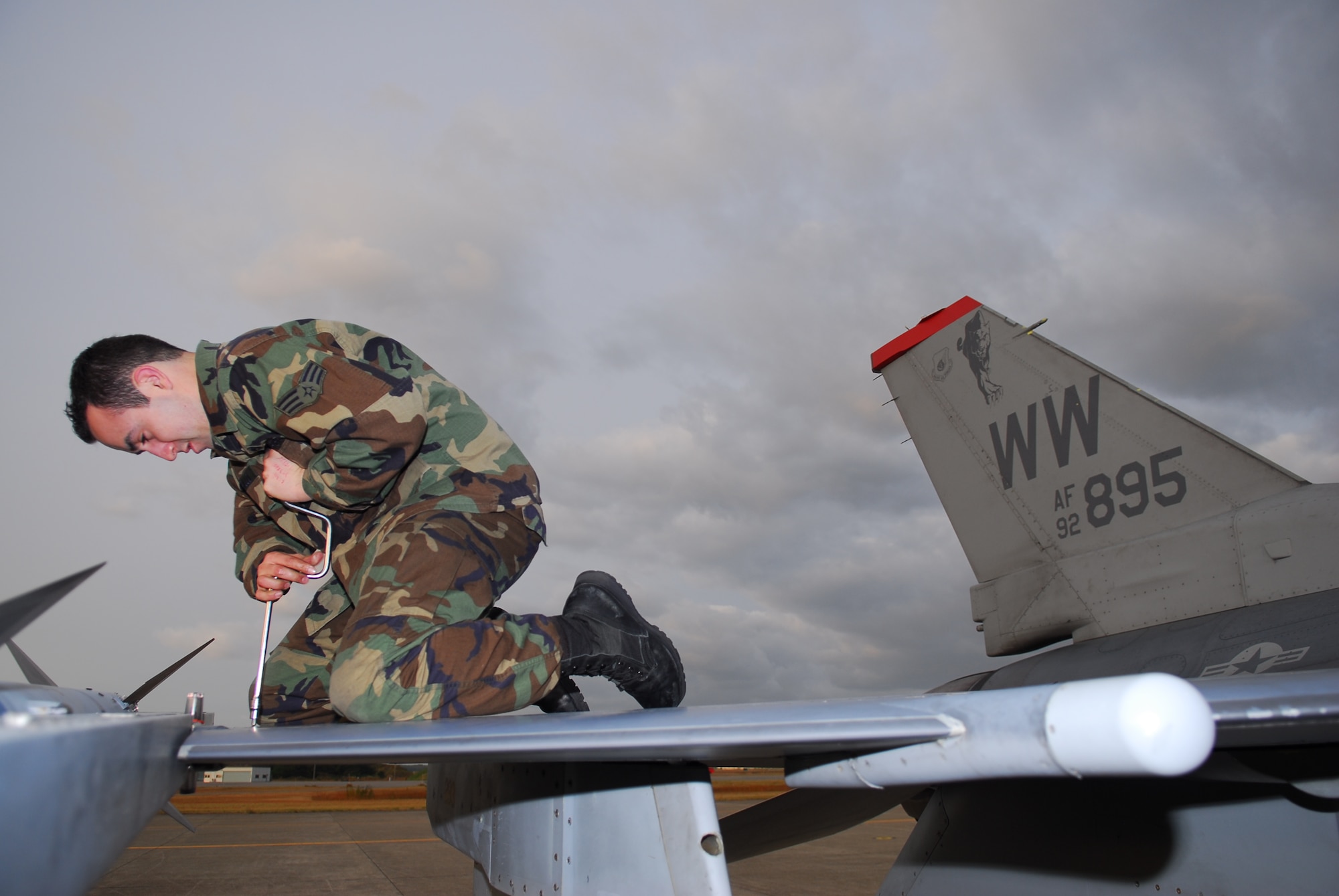 KOMATSU AIR BASE, Japan—Senior Airman Chris Cerrillo, 13th Aircraft Maintenance Unit crew chief, tightens screws on the wing of an F-16 Fighting Falcon, Nov. 16, at Komatsu Air Base, Japan. Just like any vehicle, screws come loose and require tightening. (U.S. Air Force photo/Staff Sgt. Phillip Butterfield)