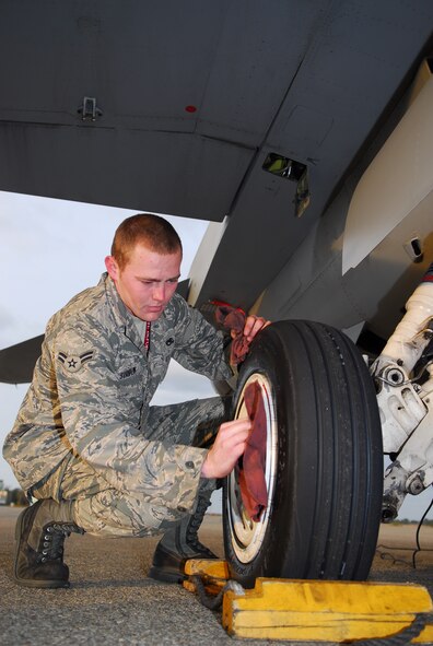 KOMATSU AIR BASE, Japan—Airman 1st Class Phillip Striplin, 13th Aircraft Maintenance Unit crew chief, wipes the grime off an F-16 Fighting Falcon’s wheel, Nov. 16, at Komatsu Air Base, Japan. Komatsu AB is the host to an alternate training relocation event, where the 13th Fighter Squadron was invited to attend. (U.S. Air Force photo/Staff Sgt. Phillip Butterfield)