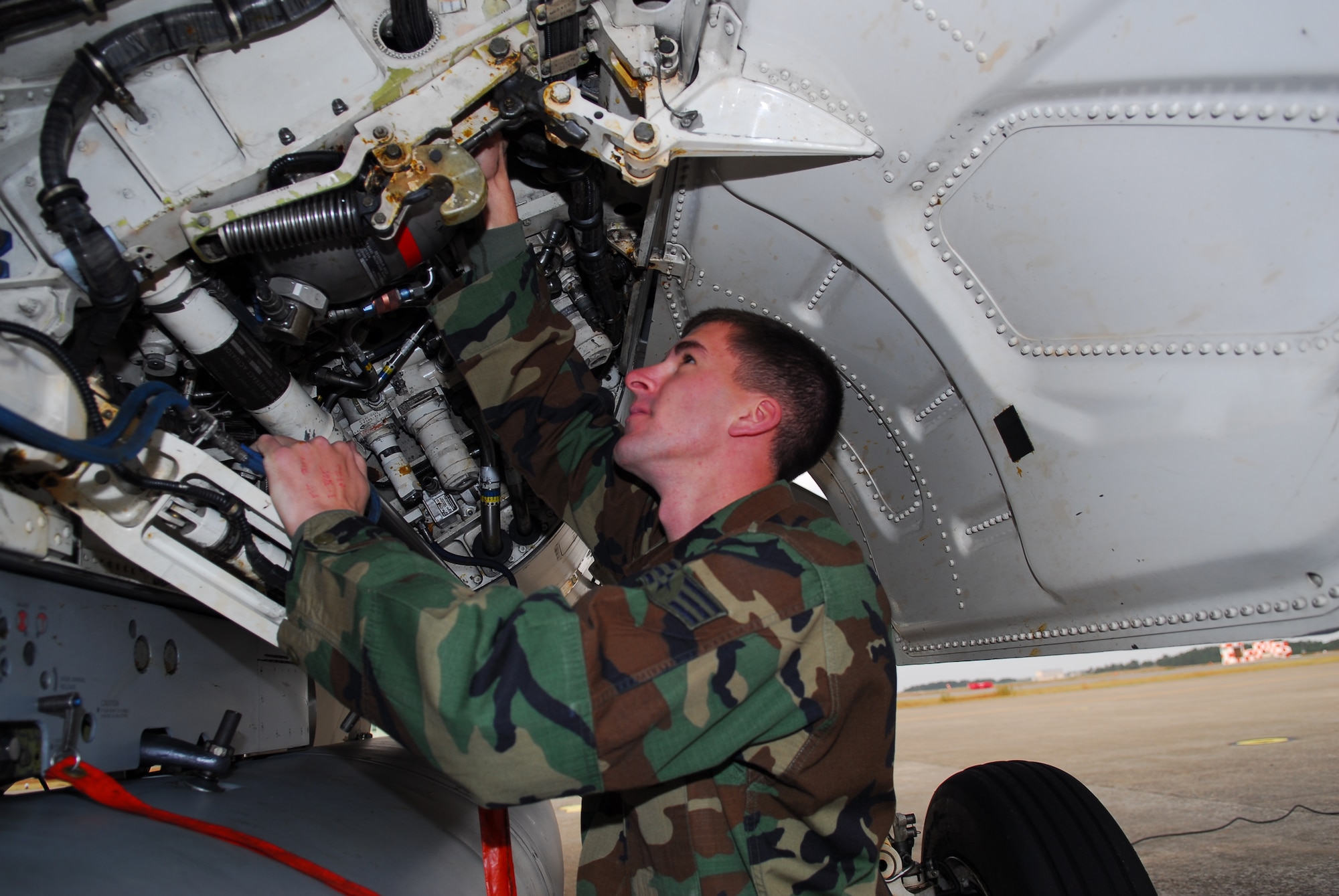 KOMATSU AIR BASE, Japan—Senior Airman Aaron Hasenauer, 13th Aircraft Maintenance Unit crew chief, inspects hydraulic lines in the left wheel well of an F-16 Fighting Falcon, Nov. 16, at Komatsu Air Base, Japan. Airmen Hasenauer is one of 13 crew chiefs deployed to Komatsu from Misawa AB. (U.S. Air Force photo/Staff Sgt. Phillip Butterfield)